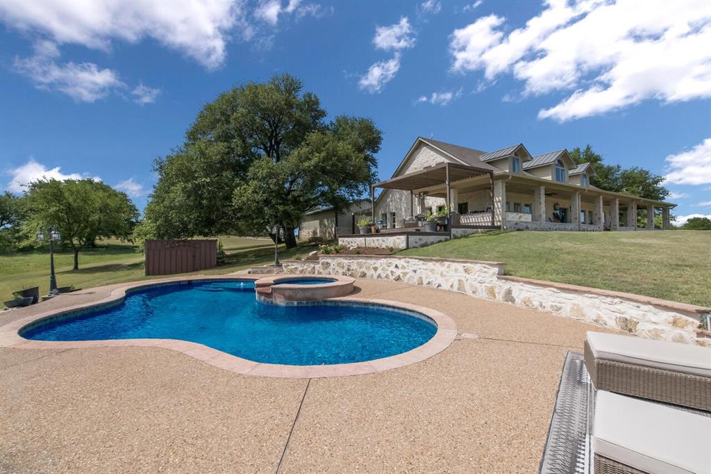 Masterfully planned HILLTOP estate overlooking a spring fed creek in a gorgeous Bosque County setting just minutes to Lake Whitney, China Spring and Clifton! This 30 acre property has a country resort like feel with a gorgeous pool, HUGE porches, a
MASSIVE workshop with quest quarters. brand new 3 car garage. a stunnina gated entry-wav with pavina the entire wav to the house and much much more! The main home features 3,999 square feet of living space that has been GORGEOUSLY redesigned with luxury finishings and details throughout each room that look straight out of a magazine. There are 4 spacious bedrooms, 3 full bathrooms, a STUNNING dining area, decked out kitchen, cozy living space and a dreamy and secluded master suite that is downstairs. The upstairs has a loft flex space, gun room and wonderful views throughout each space. On the exterior you will
entov endless entertainina and recreational oddortunities. From watching deer and wild turkev from the tront dorch to hiking down the rocky flowing creek your guests will be blown away by every detail on this property. They will also enjoy staying in the equally as well designed guest apartment that sits within the large workshop. This property has been updated with all new energy efficient AC units, spray foam insulation and even a 75,000 kw 187 watt generator that will immediately kick in if there is ever a power outage. This property is even more impressive in person and is ready for you to call it your own!