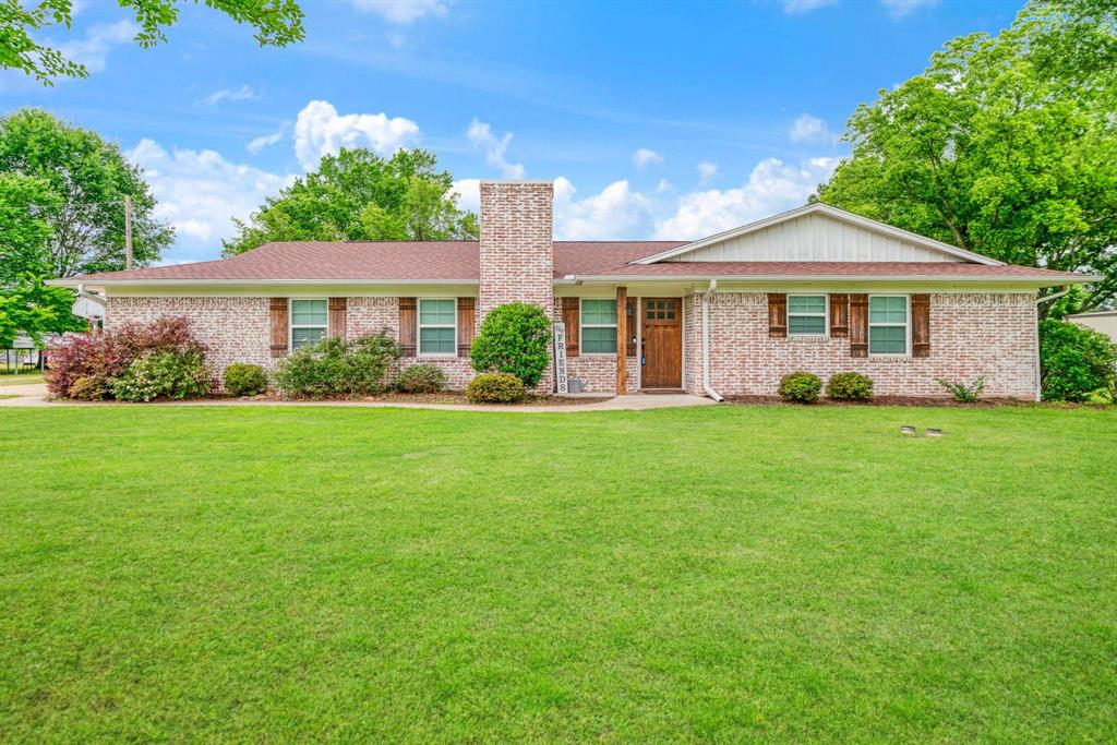 Charming country property just outside the city limits of Paris offering comfort, updates, and income potential on nearly 1 acre. This 3-bedroom, 2-bath brick home features a spacious layout with wood-look tile flooring throughout and a cozy living room anchored by a fireplace with gas logs. New Roof May 2026. The updated kitchen includes modern appliances and granite countertops, with matching granite carried throughout the home. Both bathrooms have been tastefully updated with stylish tile and contemporary finishes, creating a clean and inviting feel. Enjoy peaceful outdoor living with plenty of space to spread out including a covered back patio. A standout feature is the income-producing accessory dwelling unit (ADU) offering approximately 800 square feet of shop space with an attached carport, currently leased for $700 a month—perfect for supplemental income or future flexibility. Additional improvements include a storm shelter and a storage building for added functionality. Located in NLISD, this property blends country living with practical amenities and investment opportunity.