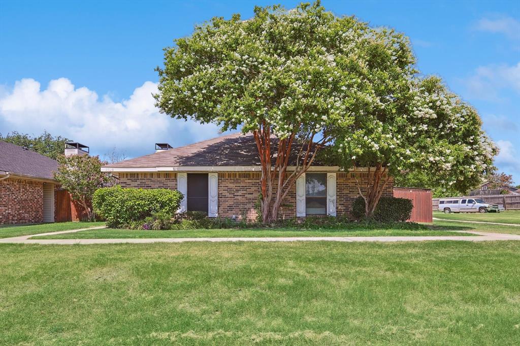 Location! Location! Location! Just minutes from Hwy 161, this well-maintained half duplex in the heart of Carrollton offers a prime opportunity for convenient living with access to a community pool. The home faces a beautiful greenbelt, ideal for walking, exercise, and outdoor activities. Inside, you'll find a spacious living room featuring a stunning stone fireplace. The kitchen is equipped with granite countertops, updated cabinets, and stainless steel appliances. The living room and kitchen have engineered wood flooring, while the bedrooms feature updated vinyl floors. The split bedroom floorplan offers space and privacy for everyone. The fenced side yard is perfect for pets and entertaining. Additional features include a covered carport for 2 and a small storage area behind the property. Newer air conditioner replaced June 2024.  Come and view this beautiful home today!