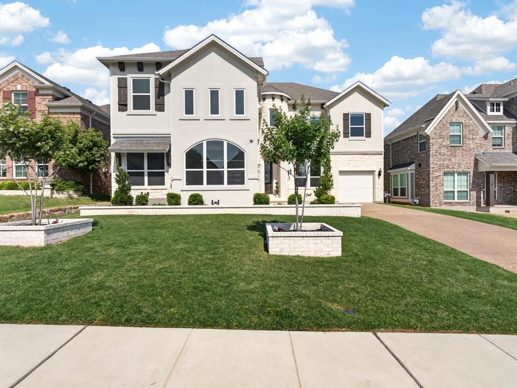 Welcome to 3804 Diamond Rdg, a dramatic McKinney home designed around light, volume, and everyday livability. From the moment you step inside, the spiral staircase sets the tone, creating a true statement entry that feels elegant, open, and memorable.
The main living space is where the home really comes alive. Soaring ceilings and oversized windows lining the back and side walls fill the room with natural light, creating a bright, airy setting that feels impressive without losing warmth. Morning light, backyard views, and open sightlines make the living, kitchen, and dining areas feel connected for both quiet days at home and larger gatherings.
The kitchen offers a clean designer feel with white cabinetry, a large island with seating, double ovens, gas cooktop, gold-tone hardware, and generous storage. It opens naturally into the main living area, making the heart of the home feel spacious, polished, and easy to enjoy.
The layout gives you room for real life, with a private study, spacious bedrooms, well-appointed baths, and upstairs game and media-style spaces that can flex for movie nights, homework, guests, or a second lounge. The primary suite feels calm and oversized, with a spa-inspired bath featuring dual vanities, a freestanding tub, separate shower, and elegant tile detail.
Out back, the covered patio and fenced yard create an easy outdoor extension of the home, perfect for morning coffee, dinners outside, pets, or play.
Located in McKinney’s Wilmeth Ridge area, this home offers convenient access to US-380, US-75, shopping, dining, parks, and the growth corridor connecting McKinney, Prosper, and Frisco. Zoned for Prosper schools, this home brings together the space, light, location, and elevated everyday lifestyle buyers are looking for in one of North Texas’ most desirable pockets.