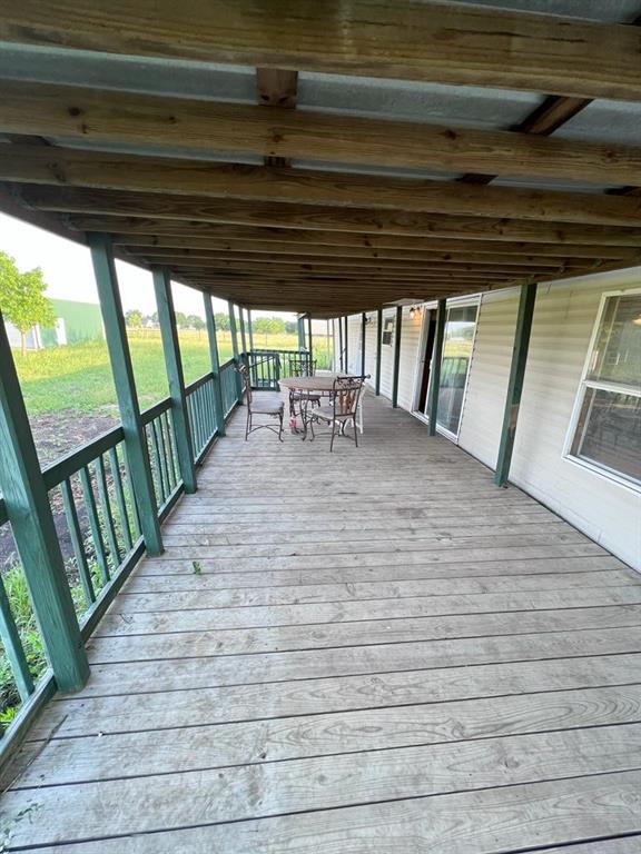 For Sale at Land Value. Double-wide manufactured home situated among mature trees in a serene setting just off FM 455 in Anna. Home is currently not in use and seller has no information on its condition — buyer to perform full due diligence and inspect accordingly. Home is sold strictly as-is with no repairs or concessions from seller. Property includes covered front and back decks, 13x30 carport with attached storage workshop, RV covered parking, and a 30x30 metal shop building on slab with electric. Home is part of a larger acreage tract; land available for use is fenced around the home. All information to be independently verified by buyer. Please note: photographs shown are from a prior date when the home was occupied and in use. Photos are provided for general reference only and are not representative of the home's current condition.
