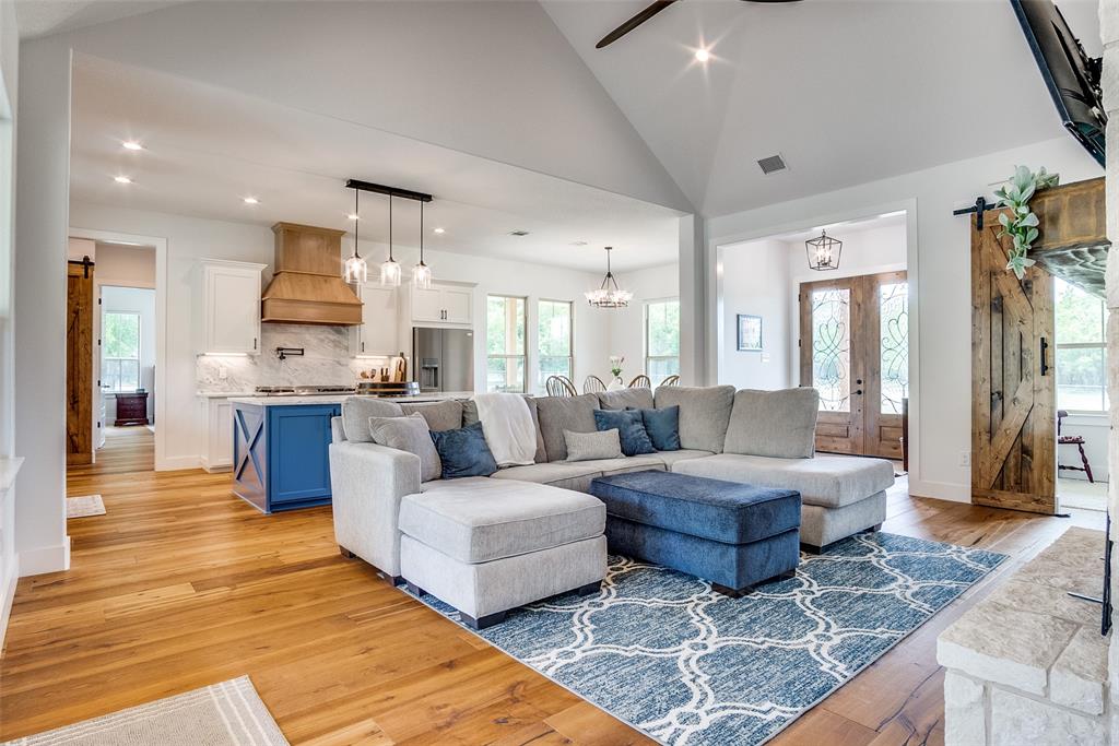 Beautifully constructed 3-bedroom, 2.5-bath custom home situated on 52+- acres in Grandview, TX. This home features quality craftsmanship throughout, including custom woodwork, barn doors, and a floor-to-ceiling stone fireplace in the open living area. The metal roof provides long-term durability and low maintenance. The open-concept kitchen includes a large island, stainless steel appliances, ample cabinetry, and generous counter space.

The spacious primary suite offers a walk-in shower with dual rain shower heads, double vanities, and a large walk-in closet. Secondary bedrooms are well-sized and suitable for guests and family. The home also features a dedicated laundry room, dedicated office flex space, and a two-car garage.

Outdoor features include a covered patio, full-length front porch, custom pipe-and-no-climb fencing around the yard, and mature trees. The property is currently under an agricultural exemption and is well-suited for livestock, horses, or recreational use. Located just minutes from downtown Grandview and major highways, this property provides both privacy and accessibility. 

10 minutes to Cleburne, 40 minutes to downtown Fort Worth