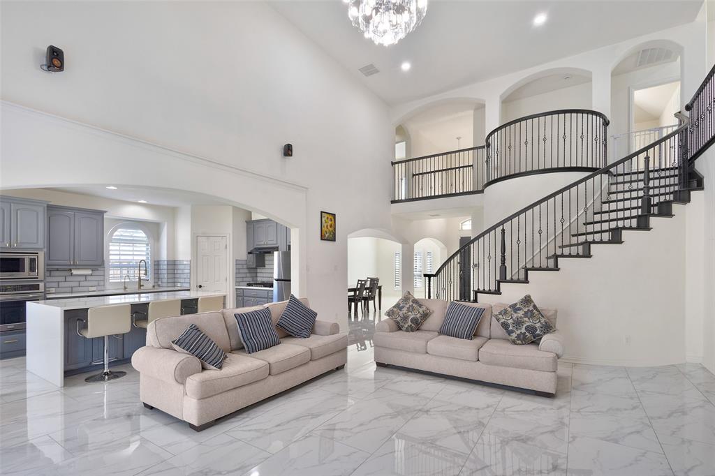 Stunning East-Facing Corner Lot Home with Over $125,000 in Upgrades in Highly Acclaimed Prosper ISD! This move-in-ready 5-bedroom home offers the perfect blend of luxury, comfort, and functionality. Step inside to soaring ceilings, abundant natural light, oversized porcelain tile flooring, a grand curved wood staircase, and a dramatic floor-to-ceiling fireplace. The gourmet kitchen is a chef's dream, featuring quartz countertops, a gas cooktop, convection oven, motion-sensor vent hood, ceramic farmhouse sink, and built-in RO + UV water purification system. The spacious primary suite provides a private retreat with a sitting area, dual vanities, soaking tub, separate shower, and oversized walk-in closet. Upstairs boasts a large game room, fully equipped media room, four secondary bedrooms, and two full baths including a Jack-and-Jill layout. Enjoy outdoor living year-round with a covered patio, storage building, and custom JellyFish exterior lighting. Located near Prestwyck Park, community pool, walking trails, top-rated schools, shopping, dining, and entertainment. This exceptional Prosper ISD home truly has it all!