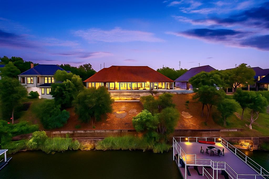 6,100+ SQ FT WATERFRONT MASTERPIECE, TRIPLE LOT ESTATE, LAKE GRANBURY LUXURY!

Experience unparalleled Mediterranean elegance in this recently remodeled 6,100+ SQ FT estate, perfectly positioned on THREE PREMIER LOTS with breathtaking, panoramic WATERFRONT VIEWS from nearly every room. Located in the heart of Granbury, this custom-built residence blends timeless architectural detail with modern luxury upgrades, offering a lifestyle of sophistication and serenity.

ELEGANT INTERIORS & CUSTOM DETAIL Step into an expansive open-concept floor plan highlighted by rich wood flooring, high-end finishes, and soaring ceilings. This 4-bedroom, 4.5-bathroom estate is designed for both grand-scale entertaining and everyday comfort.

CHEF’S GOURMET KITCHEN: Features premium appliances, custom cabinetry, and generous granite workspace.

LUXURY SUITES: A massive primary retreat with a spa-like ensuite plus three additional spacious bedrooms.

ELITE AMENITIES: Includes a private home office, a dedicated home gym, two classic fireplaces, and a secure safe room for peace of mind.

RESORT-STYLE BACKYARD OASIS The outdoor living space is a private paradise designed for the ultimate entertainer:

POOL & SPA: Featuring dual water features and electric awnings for year-round comfort.

OUTDOOR KITCHEN: Fully equipped for poolside dining near your private putting green.

LAKE ACCESS: An electric stair lift provides effortless access to the water’s edge.

PRIVATE DOCK: An extra-long private boat dock offers direct access to the deep waters of Lake Granbury.

UNMATCHED VALUE & PRIVACY Complete with a 4-CAR GARAGE and rare triple-lot privacy, this Mediterranean gem is a standout in the Granbury market. Whether you are looking for a weekend retreat or a permanent luxury residence, this home delivers unmatched quality and views.

MOVE-IN READY WATERFRONT LUXURY—SCHEDULE YOUR PRIVATE SHOWING TODAY!