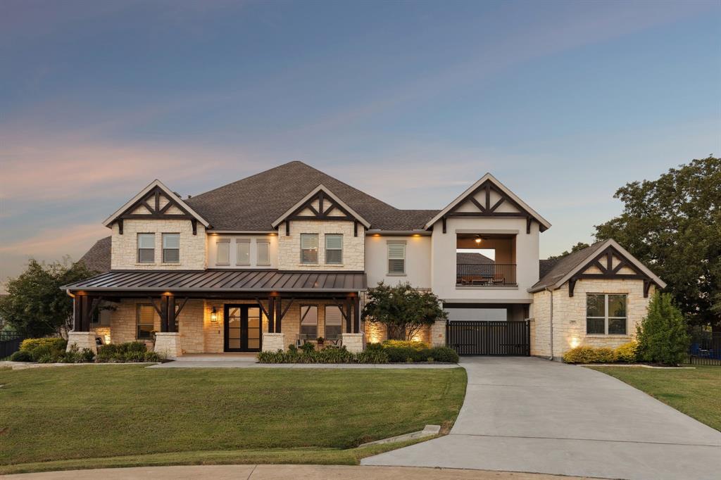 Welcome to a multigenerational home in the desirable Townlake community in Flower Mound, situated on a premium lake-facing lot at a quiet cul-de-sac. Set on 0.8 acres, this property offers generous outdoor space for activities, pets, and entertaining. An inviting front porch leads to a grand foyer with dual staircases and a private office with french doors. The open floor plan blends traditional and contemporary elements, offering abundant natural light, clean lines, and sliding glass door for seamless indoor-outdoor living. The kitchen features a quartzite island, premium built-in appliances, and a butler’s pantry. The spacious primary suite is a private retreat with spa-inspired bath, stand-alone soaking tub, walk-in shower, and his-and-hers closets. A guest quarters features its own entrance, living area, and kitchenette—creating an ideal retreat for extended family, long-term guests, or live-in support while maintaining complete privacy from the main home. Upstairs offers three ensuite bedrooms with walk-in closets, a game room, stadium sitting media room and a covered balcony overlooking the lake. The backyard is a resort-style escape with a custom Robertson’s salt water sparkling pool & spa, covered patio with fireplace, pergola, and centennial native oaks. A porte-cochère leads to a private motor court and four-car garage. New roof. Conveniently located near award-winning schools and DFW Airport.