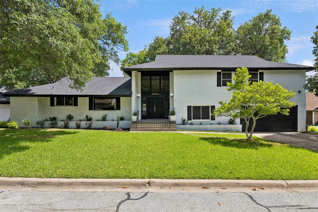 Beautifully updated split-level home in North Richland Hills featuring 4 bedrooms, 3 full baths, and a 2-car garage. The spacious layout features handscraped hardwood floors throughout, two generous living areas with fireplaces. Main living room is the heart of the home and a separate family room includes a wet bar and plenty of space for movie nights or entertaining. The fully updated kitchen has easy access to a utility room, pantry and both casual and formal dining spaces. A lower level bedroom and full bath is ideal for a home office or guest suite. Upstairs large primary bedroom includes an ensuite bathroom & two walk closets. Garage includes vinyl plank flooring for a clean, finished look. Step outside to enjoy the inviting covered patio, terrace and lovely large backyard, ideal for relaxing or spending quality time with family and friends. Within walking distance of Linda Spurlock Park and Oaks Park golf course.