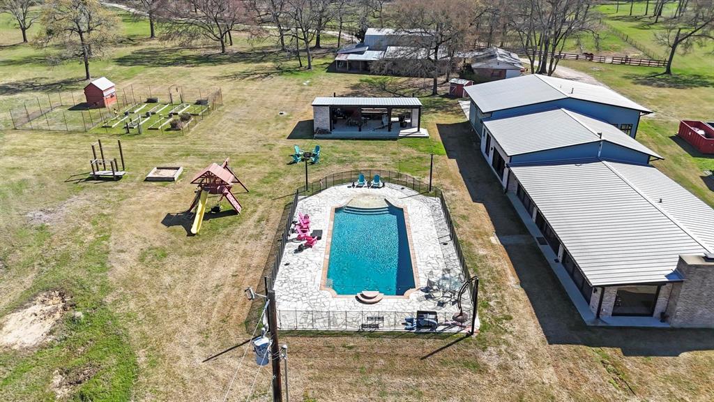 Discover a rare opportunity to own 25 breathtaking acres directly across from the beautiful Sam Houston National Forest. This thoughtfully designed modern estate offers the perfect blend of luxury living, privacy, and natural beauty. No detail has been overlooked in this immaculately crafted home. The property features a full water filtration system and whole-home backup power with a Generac generator, ensuring comfort and reliability year-round. Step outside to your private resort-style oasis. The stunning in-ground pool is the centerpiece of the outdoor space, complemented by a pool house complete with a full bathroom and dedicated storage, perfect for entertaining or relaxing after long days enjoying the land. The property also includes a fully air-conditioned office and storage space located just off the garage, ideal for working from home, hobbies, or additional climate-controlled storage. Beyond the home, the land itself is extraordinary. The 25 acres showcase expansive open space, beautiful natural surroundings, and a picturesque pond that enhances the peaceful setting. Every element of this property has been carefully thought out, creating a home that truly has it all. This is the kind of place that simply cannot be fully appreciated until you experience it in person. Schedule your private tour today and see for yourself what makes this exceptional property so special.