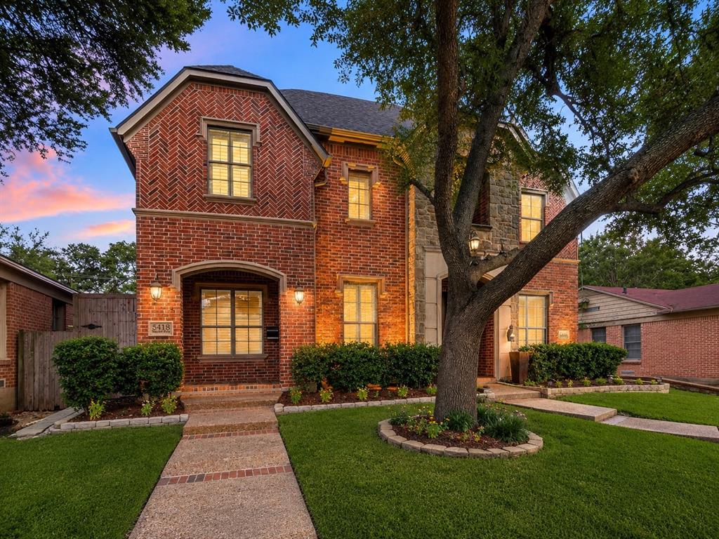 You've been eyeing the 1930s Tudors on Vanderbilt, running numbers on foundation work, knob-and-tube, and a kitchen untouched since President Carter, wondering whether a real house in a real neighborhood means a decade of weekends. It doesn't. Not on this block. 2,509 square feet. Built in 2006. Three bedrooms, two and a half baths. Two car garage, rear entry. Red brick, classic traditional. J. Gregory built it, and the bones hold. Sellers refinished the hand scraped hardwoods, replaced the lighting from chandeliers to cans, and painted throughout. Downstairs delivers. Tall ceilings. Iron spindle staircase. Crown molding. Living room with real height and a fireplace that pulls it together. The kitchen opens straight into it. Island with bar seating, granite counters, gas range, stainless, tumbled marble backsplash. You're pouring wine, someone's on a stool, someone else is setting the dining table two steps away. Nobody's stranded in another room. Push through to the covered patio. Fall football Saturdays. Summer evening margaritas. Off the main floor, a study. Home office through the week, second living when you want it. Upstairs, room to grow. Two guest bedrooms with a dedicated bath between them. A laundry room with its own walls, not a hallway closet. A second living area with a wet bar, fridge, and beamed ceiling. Master suite with vaulted ceilings and floor space for a chair and a lamp, not just a bed. Bath with travertine accents, jetted tub, separate walk in shower, dual vanities, and a walk in closet built for two. Glencoe Park across the street. Nine acres. Trails, tennis, basketball, playground, softball, rugby, shade. Attached home in central Dallas, and you still get a yard. You just never mow it. Walk to the Granada, Cafe Izmir, Terilli's, Gloria's, Aw Shucks. Two minutes to Truck Yard, HG Sply Co, Trader Joe's, Mockingbird Station. Katy Trail a quarter mile out. The M Streets address. The park. The walk to Greenville.