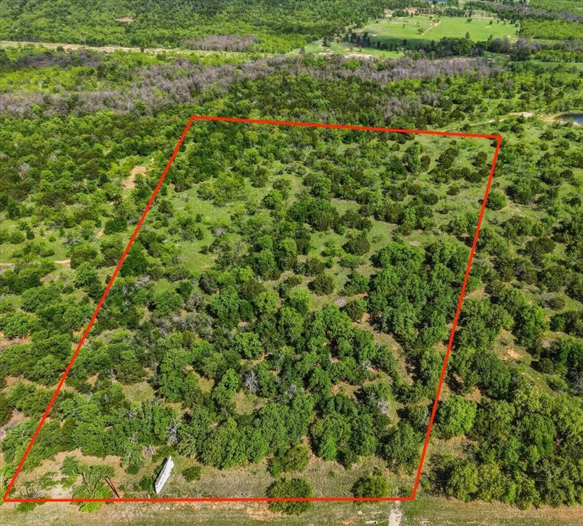 Multi-zoned, usable tract of land with great I-20 service road frontage.  Water meter already in place.  For the residential consumer, the landscape, towering oak trees, and hilltop views to the north make this a setting for future homestead fitting.  For the commercial investor, visibility off I-20 and service road access make possibilities endless.  Directly across the new Holiday Ford dealership, this area is growing and calling for more businesses and opportunities.  Existing billboard already located on land.  Property is fenced on 2 sides.