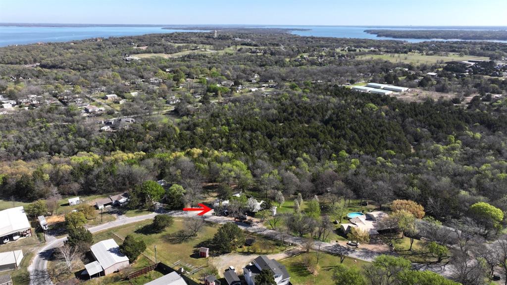 Do you want a home with a treehouse feel? Discover your own woodland retreat with this 1.058-acre lot nestled among mature trees, adjoining Corps of Engineers land for added privacy and natural beauty. Enjoy the peaceful ambiance of a creek below leading to Lake Texoma. The lot has been recently surveyed, with flags marking the boundaries, and partial clearing reveals its potential. Set back from the road, you’ll appreciate the quiet surroundings and minimal street activity. Utilities are ready, with electricity and water to the lot, and a septic system already installed for added convenience.

Located just off Highport Road and near Highport Marina, this property offers quick access to HWY 289, making dining, shopping, and entertainment in Pottsboro, Texas, easily accessible. Local favorites like Brookshire’s Grocery Store and Ace Hardware are conveniently nearby, along with several excellent dining options.

This versatile neighborhood allows for site-built, manufactured, or container homes, giving you flexibility to build the home that suits your needs. Imagine your dream residence—whether a split-level home or another unique design—on this scenic lot. Come explore and see the possibilities for yourself! All potential buyers are welcome to consider this property and its many options.