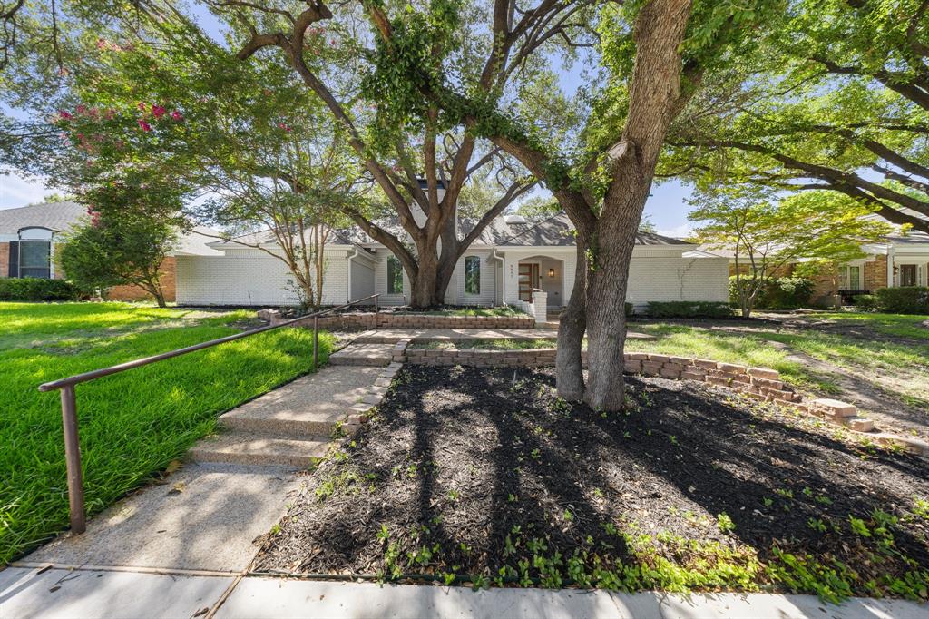 Ideally positioned in the highly sought-after Town Creek neighborhood of Lake Highlands, prized for its exceptional location just minutes from Highways 635 and 75, exemplary Richardson ISD schools, and picturesque setting with mature trees and direct access to a scenic 1.3-mile walking trail, this stunning mid-century-style home is a rare find. As you step inside, you're greeted by an enchanting private courtyard that blurs the line between indoor and outdoor living, offering endless possibilities to create a lush garden retreat, intimate entertaining space, or simply a one-of-a-kind statement feature that guests will never forget. The breathtaking family room captivates with its soaring vaulted beam ceilings and striking stone fireplace, while the adjacent wet bar invites effortless entertaining or can easily be transformed into a stylish coffee or wine bar. The timeless kitchen offers the perfect blend of style and function, featuring double ovens, extensive cabinetry, expansive prep space, and a large center island perfectly positioned between the casual breakfast nook and the elegant dining area, creating an ideal layout for both intimate gatherings and large-scale entertaining. The spacious primary retreat offers a peaceful escape, complete with a spa-inspired bath featuring a soaking tub, oversized walk-in shower, dual vanities, and two generous walk-in closets—creating the perfect place to relax and unwind at the end of the day. Completing this exceptional home are three generously sized secondary bedrooms, two full baths, and an oversized garage with a dedicated storage area, offering abundant space for everyday living and organization. Enjoy an exceptional Lake Highlands lifestyle with White Rock Lake, the Dallas Arboretum, the private school corridor, premier shopping, dining, and quick access to Highways 635 and 75 all just minutes from your doorstep.