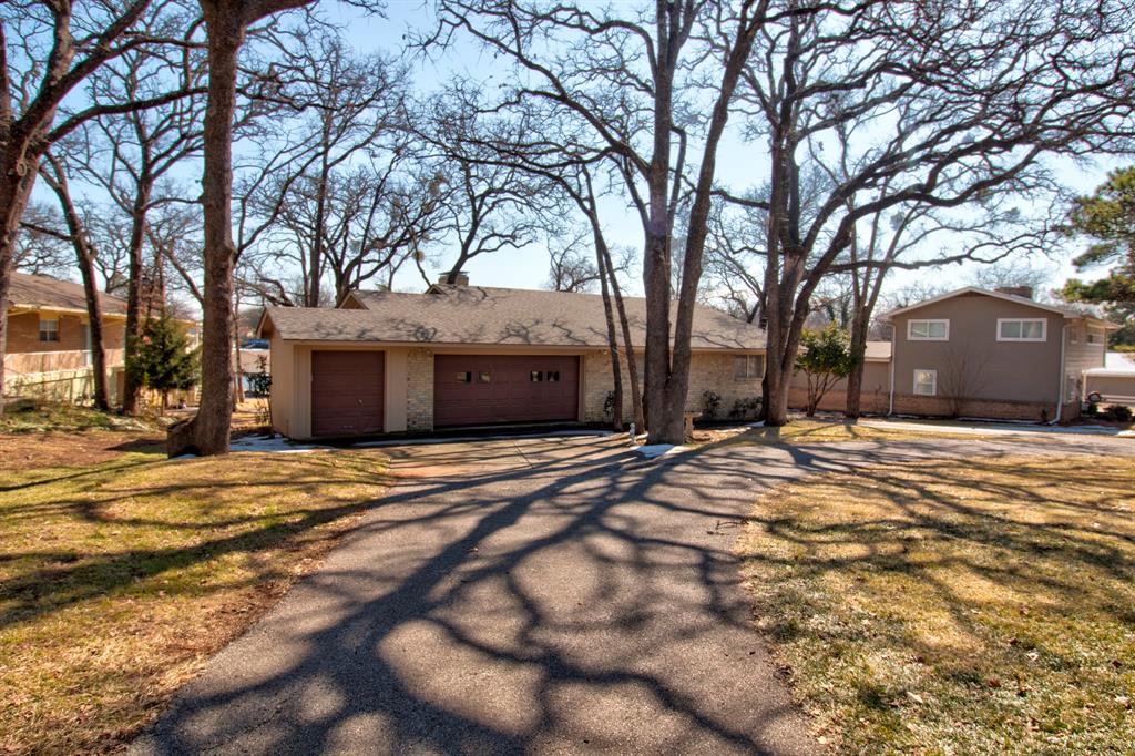 This well-built lakefront home on Lake Kiowa offers a versatile design on a quiet cove that opens to the main lake.  There are so many ways to update this one to create your own lakefront retreat!  See photos for some ideas! The upper level features a spacious living room, dining area, and kitchen that flow together and open to a balcony with beautiful lake views—perfect for relaxing or entertaining. The entry level includes three bedrooms, two full baths, and a laundry room, highlighted by a master suite with a private balcony showcasing stunning lake views. The lower level provides a large open second living area or game room with a half bath, a small office area, and a generous walk-in closet offering excellent storage, with sliding doors that open to a walk-out patio and direct access to the lake and boat dock. Both upstairs and downstairs living areas feature wood-burning fireplaces with Heatilators that blow the warm air creating cozy gathering spaces on cooler days. The kitchen is move-in ready with like-new appliances and granite countertops, while the rest of the home offers an opportunity for cosmetic updates to make it your own. Owned by the same family since construction, this solid home also features a built-in golf cart shed, a circle drive with ample parking, and a location that provides easy access in and out of the Lake Kiowa community—ready for years of family lake fun.