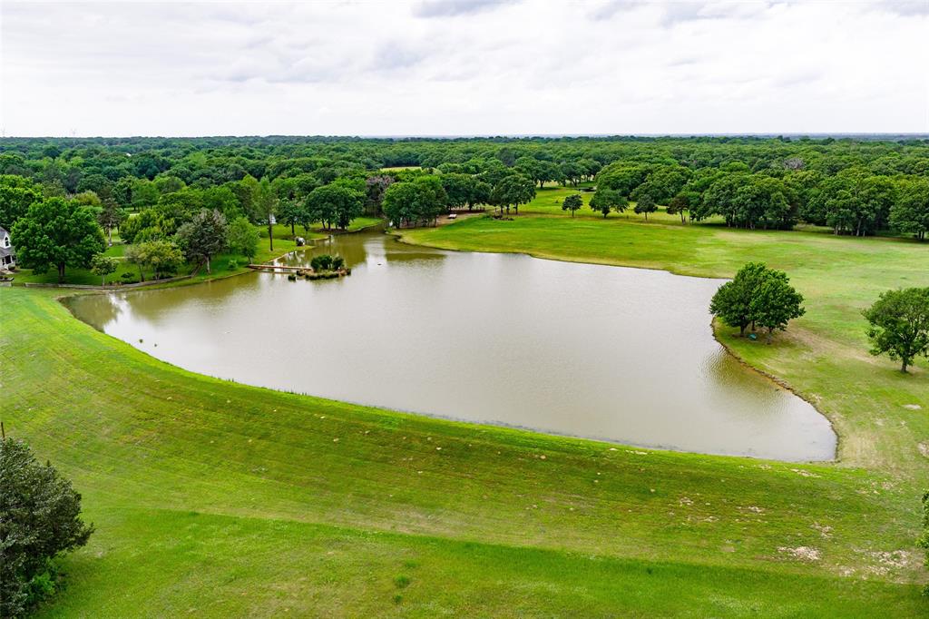 Just an hour east of Dallas and a few miles northeast of Wills Point lies The Pharme, an incredible secluded retreat. In addition to exceptional fishing and hunting, the property has been utilized as a horse breeding facility. This conveniently located ranch is also just minutes south of Lake Tawakoni, well known for its fishing and water sports.
The property offers easy access, located only a few miles north of US Highway 80. The entrance is set along a very private county road, leading to a code-accessed gate and a beautiful tree-lined drive that winds to the home overlooking park-like pastures and a ±5-acre lake.
The 190 acres consist of a combination of excellent hay pastures and native woods, providing ideal habitat for livestock, horses, and wildlife. This East Texas gem has been lovingly cared for by the same family for decades and is now ready for a new owner to appreciate and steward it for years to come. There is little left to do but move in and begin enjoying the tranquility of The Pharme.
Land:
The land and vegetation at The Pharme are notably diverse. As you enter through the main gate and travel the tree-lined drive, you are greeted by park-like pastures with horses grazing on either side, creating a truly picturesque setting.
The 190-acre property is a blend of native woods and improved hay pastures, complemented by approximately nine stock tanks that support livestock operations. A small vegetable garden is also located on the property.
The terrain consists of both flat and gently rolling pastures, typical of this region of East Texas. Soils include a mix of sandy loam and clay. The property is fenced and cross-fenced to support efficient land and livestock management.