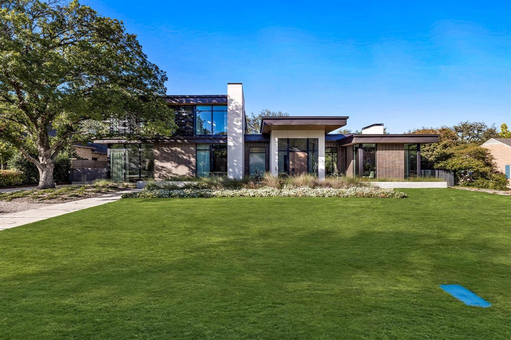 Completed in 2019 by Cole & Company, this custom modern is truly spectacular. This masterpiece is situated on a 125 x 174 lot and features 5 bedrooms, 5 and one half bathrooms, a 3-car garage, home office and playroom. A custom iron and wood pivot door welcomes you into a large foyer with soaring ceilings. Natural light abounds with floor to ceiling windows and accordian doors that open 28 feet to the outdoor living area. The kitchen features a 12 foot long kitchen island and stunning Bertazzoni Range, dual dishwashers, wine refrigerator, butler's pantry and bar. The downstairs primary suite features a separate sitting room and large walk in closet with island, soaking tub and heated terrazzo floors in the bathroom. Other features include custom metal work on the interior and exterior, solar power, Ann Sacks tiles, custom outdoor water feature and landscape design by Bonick Landscaping.