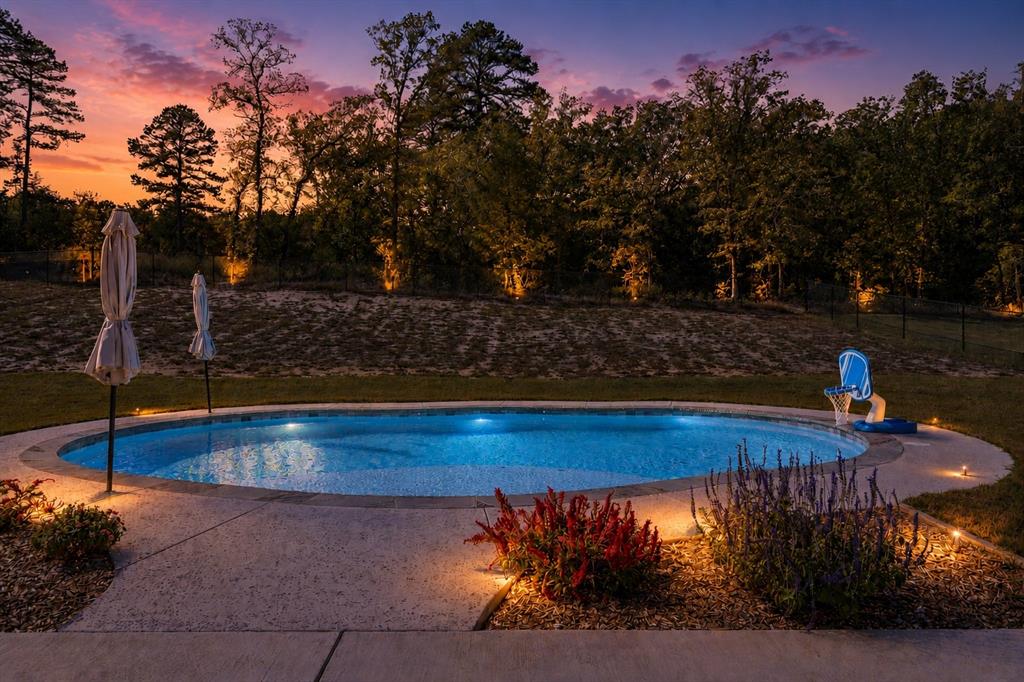Welcome to this beautiful custom home built in 2021, located in the prestigious Reserve at Tuscany community in Mineola. Situated on over half an acre, this 3-bedroom, 2.5-bathroom gem offers luxury living, thoughtful design, and a backyard oasis complete with a private pool.
From the moment you arrive, you'll be drawn to the home's charming curb appeal—featuring cedar shutters, a welcoming covered front porch, and a modern yet timeless architectural design. Step inside to an open-concept floor plan with vaulted ceilings, luxury vinyl plank flooring, and a seamless flow perfect for entertaining and everyday living.
The gourmet kitchen is a chef’s dream, boasting custom cabinetry, granite countertops, tiled backsplash, a Bertazzoni gas range, built-in microwave, a versatile island, and an oversized walk-in butler’s pantry.Retreat to the spacious primary suite, complete with a large walk-in closet, dual vanities, a whirlpool tub, a fully tiled walk-in shower, and a dedicated linen closet. Two additional bedrooms share a well-appointed full bath, and guests will appreciate the separate half bath.The home also features a large utility room with built-in cabinets, countertops, and a sink for added convenience.
Step outside to your private backyard retreat—a covered patio with an outdoor kitchen area, perfect for dining or relaxing poolside in the Texas sun.
Don’t miss the opportunity to own this exceptional home that offers the best of style, space, and comfort in one of Mineola’s most sought-after neighborhoods, best of all NO HOA.