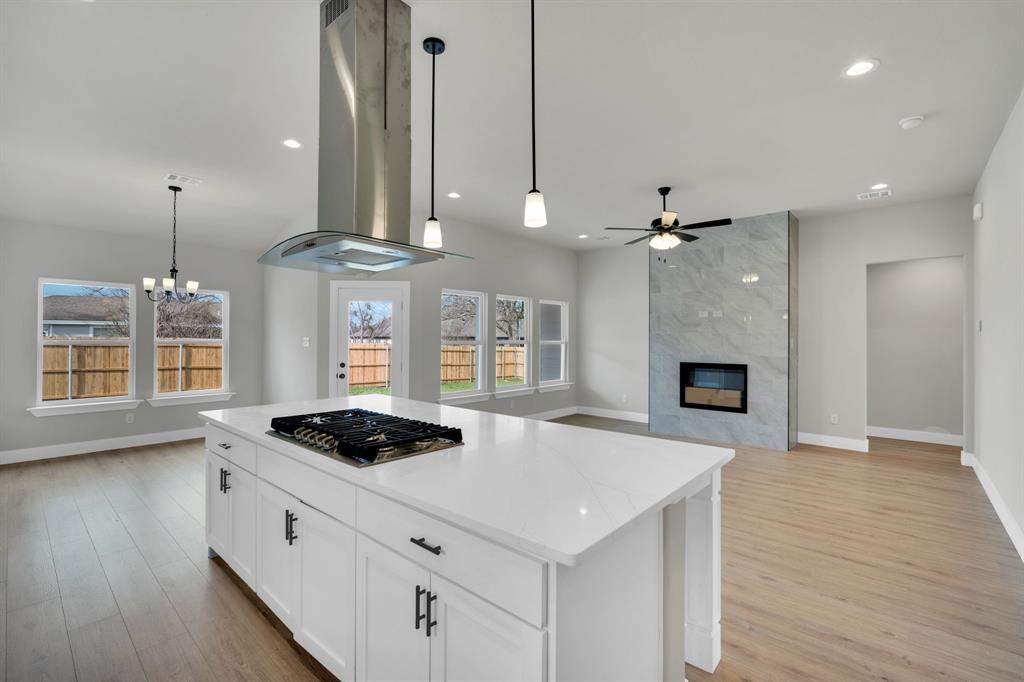 New Construction home - No HOA - in the Copper Penny Estates community in Palmer, TX! This stunning 4-bedroom, 2-bath home blends modern style with everyday comfort and is designed for both entertaining and family living.
The gourmet kitchen is truly the heart of the home, featuring a gas cooktop, exposed stainless steel vent hood, quartz countertops, abundant cabinetry, and a massive center island perfect for gathering. Luxury vinyl flooring flows throughout the main living areas, adding both durability and style.
The open living room and breakfast area are filled with natural light and highlighted by a dramatic floor-to-ceiling tiled electric fireplace with heat blower and multi-color flame options, creating a striking architectural focal point.
The private primary suite offers a tray ceiling, ceiling fan, and a spa-like en-suite bath complete with dual quartz vanities, soaking tub, separate shower, and a custom walk-in closet. A split-bedroom layout provides added privacy for the primary suite.
Step outside to a large fenced backyard with a covered patio—ideal for relaxing evenings or weekend entertaining. Additional features include a spacious utility room with cabinets, utility sink, and drip area for added convenience.
Located in the charming Copper Penny Estates community in Palmer, TX. Ask about Incentives