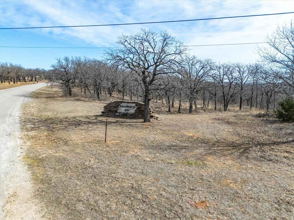 TWO ACRES on a corner lot!! The lake is FULL- so come and see this perfectly perfect location to build your next home.  This two-acre tract has open area and a mixture of trees. You can bring your own builder! No HOA! Deed restrictions are in place to protect your future investment.  Runaway Bay is a charming small community where you can plant roots.