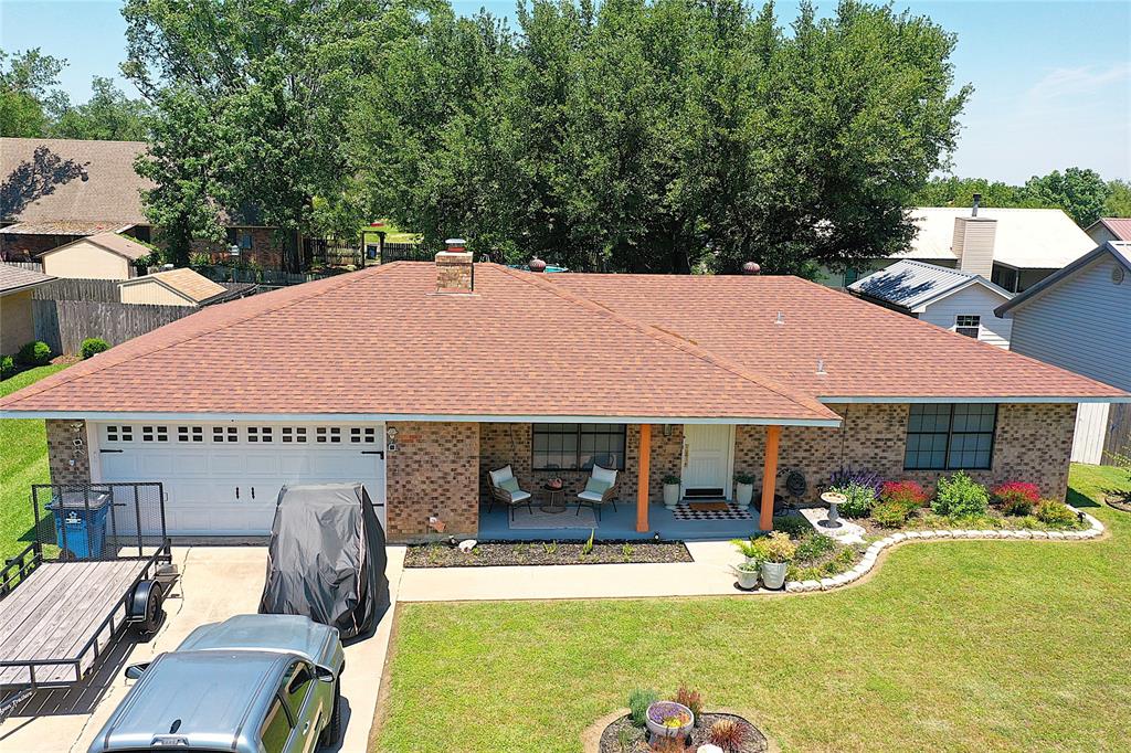 Nestled in a quiet Mexia neighborhood, this beautiful three-bedroom, two-bathroom brick home features a spacious two-car garage and a perfect blend of modern upgrades. New flooring, fully updated bathrooms with stylish subway tile, and kitchen equipped with granite countertops, a glass cooktop, and a stainless steel Whirlpool side-by-side refrigerator. For ultimate comfort and efficiency, the home includes a 2023 Carrier HVAC system managed by a smart NEST thermostat, alongside an integrated NEST doorbell camera for enhanced security. Outside, the property opens up to a beautifully landscaped yard complete with several raised beds already planted with vegetables and herbs. A versatile 10x10 workshop or storage shed is on a concrete slab floor & includes a window air conditioner.  Perfectly situated for convenience, the home sits within safe walking distance to local schools & shopping and offers quick access to premier outdoor recreation like camping, boating, and fishing at nearby Lake Mexia and Fort Parker State Park. Centrally located between Interstate 45 and Interstate 35, this exceptional property offers peaceful small-town living with the convenience of an easy commute to both Dallas and Houston.