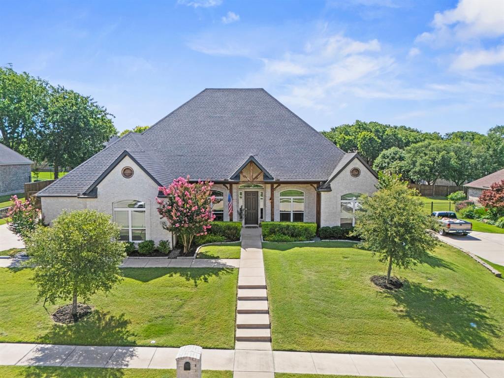 Stunning curb appeal. Immaculate, well-maintained 4-bedroom, 3-bath home in the highly sought-after Katy Lake on the Green blends the best of comfort, functionality, and resort-style living. Situated on a quiet interior lot in the heart of Ellis County, you’ll love the sense of friendly community and small-town charm—while still enjoying quick access to I-35, schools, dining, and local shops. Step inside to discover a thoughtfully designed open-concept layout, ideal for family living and entertaining. The spacious living area boasts tall ceilings, large windows that flood the home with
natural light, and a cozy gas fireplace. A well-appointed kitchen features a large island, quartz countertops, gas cooktop, and ample cabinetry—providing more than enough space and storage for everyday life or hosting gatherings. Custom moldings, decorative lighting, and built-in shelving throughout add warmth and character. The split-bedroom layout offers privacy, with the 4th bedroom featuring an ensuite bath—perfect for a guest suite or MIL retreat. The serene primary suite includes a spa-like bathroom with soaking tub, dual vanities, walk-in shower, and expansive closet. A flexible second living area can serve as a formal dining room or a game room for the kids. The dedicated home office includes his & her custom desks and built-ins—ideal for working from home or managing a busy household. Step outside to your private backyard oasis featuring a custom-designed swimming pool with tanning ledge, relaxing water features, a putting green, and an oversized covered patio with wood-burning fireplace—designed for year-round enjoyment. Golf enthusiasts will love the private golf cart access to Waxahachie Golf Club, just a short walk away. The oversized 3-car garage has plenty of room for all your toys, including your golf cart. This is the one where space, style, and location meet—your dream home in Katy Lake on the Green awaits! Schedule your private showing today!