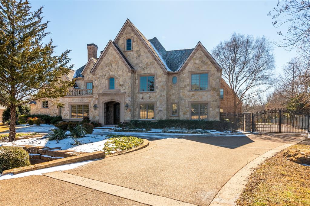 Fall in love as you peer over your balcony and see the beautiful ponds and walking trails accessible from your own walk-thru gate. Perfect any time of the year; especially fall as leaves cover the entire path. Gated neighborhood is quiet, serene and Carroll ISD or Westlake Academy approved. The entry is dramatic as your eyes follow the quality workmanship of wood moldings, stone, leaded glass, barrel and coffered ceilings plus elaborate iron railing leading upstairs and to all balconies. Step into the family room where the outdoor pours in through the wall of butted glass.   Large Chef's kitchen offers Viking appliances including a huge gas cooktop. All bedrooms have ensuite baths and walk-in closets. Must see!