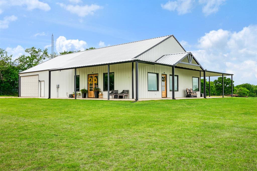 Discover the perfect blend of country living and modern comfort in this stunning barndominium-style home situated on close to 30 picturesque acres in the highly sought-after Chisum ISD. Thoughtfully designed for both everyday living and entertaining, this 2 bedroom, 2-bath home offers an open-concept and handicap friendly layout with durable concrete flooring and a spacious living area filled with natural light.

Featuring a stunning kitchen, complete with an oversized island, granite countertops, and custom cabinetry that provides both beauty and functionality. The gas cooktop, built in ovens and walk in large walk in pantry are a chef's dream! Designed to be handicap friendly, this home also includes 36-inch doorways with solid wood doors and beautiful stained concrete floors throughout. The private primary suite is oversized and a true retreat.  The en suite bath is complete with a luxurious soaking tub, walk-in shower, dual sinks, custom cabinetry, large walk in closet and ample space to relax and unwind. The impressive 30 x 40 sq ft attached garage, offers plenty of room for an RV, boat, or multiple vehicles; perfect for hobbyists, storage, or workspace needs. The home is also equipped with foam insulation for energy efficiency and built in dehumidifier. Step outside and experience everything this exceptional property has to offer. The land is fenced and cross-fenced into three sections, making it ideal for livestock or agricultural use. The front pasture is equipped with water access, and the property includes two ponds, enhancing both function and scenic appeal. Additional improvements include a 25x60 four-stall shed with power and lighting, a 25x30 two-stall shed located in the pasture, and a small fenced dog area conveniently located just off the mud room. The pasture and yard are routinely sprayed and well maintained, reflecting pride of ownership throughout.  Additional property on the southeast corner is also available, see MLS #21241780