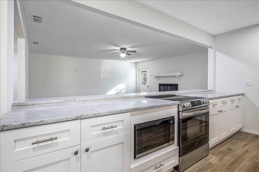 Beautifully remodeled home in the heart of Lindale, TX. Situated on a corner lot with mature trees, shaded yard and deck to enjoy the view. Inside you'll be pleased with everything brand new! Luxury vinyl plank, carpet, cabinets, countertops, paint, light fixtures, fans, stainless steel stove, dishwasher, microwave and refrigerator, and more! There are 2 living areas, wood burning fireplace, kitchenette and countertop seating. 3 bedrooms and 2 baths. Carport and storage building. New roof in 2024. Move in ready!