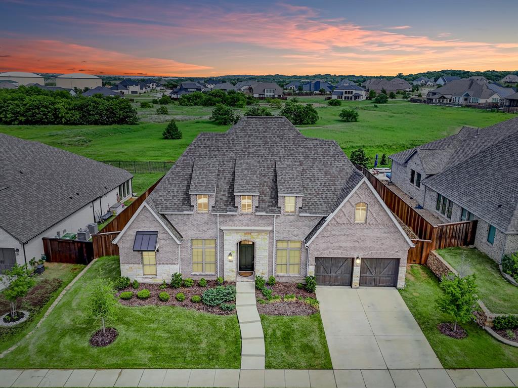 Meticulously maintained Perry one-story home located in Canyon Falls and zoned to highly acclaimed Argyle ISD with a premium lot! This home offers a thoughtfully designed, functional layout featuring a dedicated study and game room or flex space, ideal for both everyday living and entertaining. The spacious kitchen features an abundance of counter space, elevated quartz countertops, a double oven, and open-concept to the main living area. The private primary suite boasts a generously sized bedroom and an upgraded bathroom with an oversized walk-in shower with his and hers vanities. Step outside to your backyard retreat awaiting the perfect pool to be built, where a greenbelt backdrop provides added privacy and stunning sunset views! The extended patio creates the perfect space for relaxing or hosting guests. Can't forget the 3 car tandem garage. Enjoy the convenience of being within walking distance to the elementary school, with easy access to major highways. Canyon Falls offers exceptional amenities, including front yard maintenance, cable and internet services, a clubhouse with fitness center, resort-style infinity pool, splash pads, dog park and multiple playgrounds.