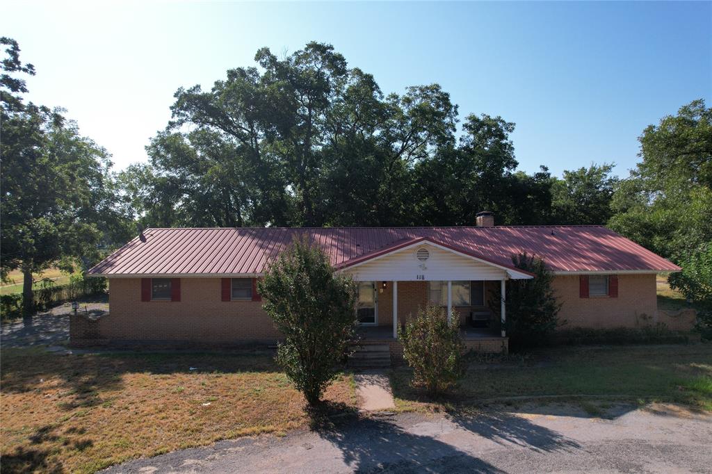 Welcome to your next opportunity.  This three-bedroom, one bathroom home with metal roof offers timeless character just waiting for your personal touch.  Featuring a fireplace, spacious backyard with mature trees, a 2-car garage, and a second unfinished bathroom space. Home also has a laundry room with shelving, sunroom, and RV shed with RV 30-amp hook-up.  This property is perfect for investors, renovators, or anyone looking to purchase a home with space. When you step inside you find a functional layout. The kitchen has updated appliances including two dishwashers.  Whether your dreaming of a modern update or classic charm this home can be your canvas.