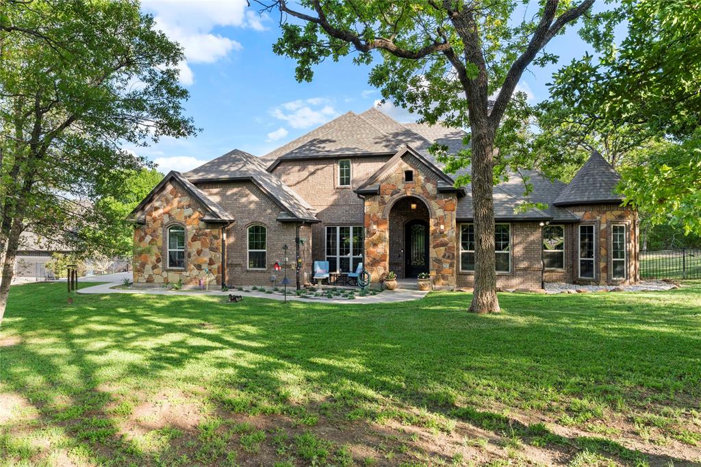 Located in the rolling hills just outside Fort Worth, Lazy JH Ranch offers a rare balance of refined luxury and authentic Texas ranch living. Ideally positioned halfway between Fort Worth and Weatherford, the property provides privacy with the convenience of a 20-minute drive to either. Spanning just over 10 ag-exempt acres, the land is currently home to Longhorn cattle and suited for those who value space, privacy, and legacy ownership.

The one-family-owned primary residence features 5 bedrooms and 3.5 baths, including a mother-in-law suite and a versatile fifth bedroom ideal as a second office. A dedicated office showcases antique double doors imported from India, setting the tone for the craftsmanship throughout. With 14-foot ceilings, 9-foot doors, plantation shutters, and walk-in closets in every bedroom, the home feels expansive yet intentional.

At the heart of the home, the chef’s kitchen features an exotic granite island, custom copper sink, alderwood cabinetry, commercial-grade double oven, and a butler’s pantry perfect for entertaining. 

Walk outside through your oversized double sliding doors to a covered patio framing a resort-style saltwater gunite pool with a stone fireplace and fully equipped gas-plumbed outdoor kitchen. The pool was recently resurfaced and all pumps replaced in 2025, and a pool-accessible bath adds additional convenience.

The guest house offers complete independence with 1 bedroom, 1 bath, laundry, a full kitchen with stainless steel appliances and granite countertops, and a stone wood-burning fireplace. An oversized three-car garage doubles as a workshop with 220V power, totaling five garage spaces. Cross-fenced acreage includes a hay barn ideal for horses or future agricultural use.

Signature details—such as the pair of 400-pound Texas stars reclaimed from a federal building in Houston—underscore the property’s character. Lazy JH Ranch is a statement of Texas heritage, elevated living, and enduring land ownership.