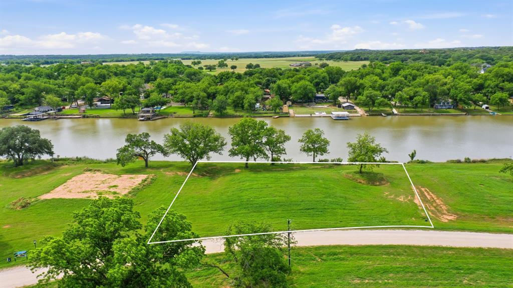 Welcome to Lot 14 at River Ranch on the Brazos , a rare opportunity to own 1.003 acres in one of Weatherford’s newest luxury riverfront developments. Nestled along the beautiful Brazos River, this premier homesite is one of the last opportunities to build your custom luxury dream home on the river in Weatherford, Texas.
Imagine waking up to breathtaking waterfront views, enjoying peaceful riverside sunsets from your private balcony, and spending weekends boating directly from your own private dock. This spacious lot offers the perfect setting for elevated luxury living with room to design the ultimate custom home, outdoor entertaining space, pool, and more. The property also features several beautiful mature trees, perfectly placed to provide natural shade, privacy, and stunning scenery for your future luxury home.
Residents of River Ranch on the Brazos enjoy exclusive community amenities including private walking and running trails, a community pickleball court, and the serenity of luxury riverfront living , all while being conveniently located near Weatherford and Granbury’s shopping, dining, and entertainment districts.
Conveniently located just 45 minutes from Fort Worth, approximately 45 miles from Dallas Fort Worth International Airport, and a 15 minute boat ride from Lake Granbury, this luxury riverfront community offers the perfect balance of peaceful country living and easy access to city conveniences and travel.
Whether you are looking to build a full-time residence or a luxurious weekend retreat, this is your chance to secure one of the most desirable riverfront homesites in Parker County.
Build your dream. Live the riverfront lifestyle. Secure your lot at River Ranch on the Brazos today before these exclusive homesites are gone.