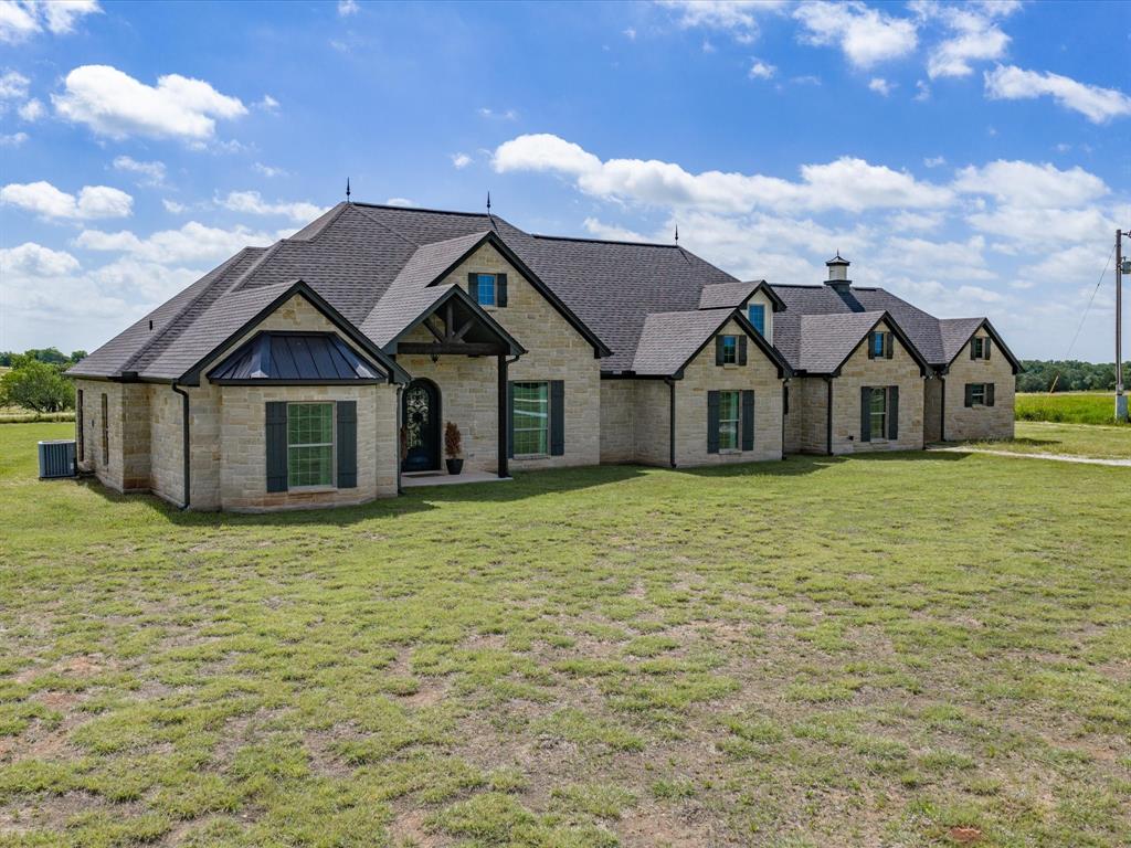Welcome to country living with custom luxury and room to breathe! Nestled on 2 beautiful acres in Bridgeport, this stunning 4-bedroom, 3.5-bath stone home offers exceptional craftsmanship, thoughtful design, and timeless finishes throughout. Step inside to a spacious open-concept living, dining, and kitchen area that was designed with both everyday living and entertaining in mind. The chef’s kitchen is a true showstopper, featuring gorgeous granite countertops, a large center island, double ovens, electric appliances, and a custom walk-in pantry with abundant storage. For those who work from home, you’ll appreciate the dedicated office space, while book lovers will fall in love with the separate library complete with beautiful French doors, custom wood cabinetry, and built-in shelving. The private primary suite is a retreat of its own, offering dual vanities, a stunning walk-in shower adorned with elegant Italian tile, and two spacious walk-in closets. Every bedroom features its own walk-in closet and convenient bathroom access, while two secondary bedrooms share a well-appointed Jack-and-Jill bath.Vaulted ceilings, beautiful crown molding, and ceiling fans throughout the bedrooms, living room, office, and library add comfort and character to every space. The attic was thoughtfully engineered to accommodate additional finished square footage in the future and includes wiring already in place along with a full walkway spanning the length of the home. Outside, enjoy peaceful views of the surrounding countryside from the backyard and experience the serenity that comes with owning acreage while still being conveniently located near town. This one-of-a-kind custom home combines quality construction, elegant finishes, and endless potential. Schedule your private showing today and discover everything this exceptional Bridgeport property has to offer!
