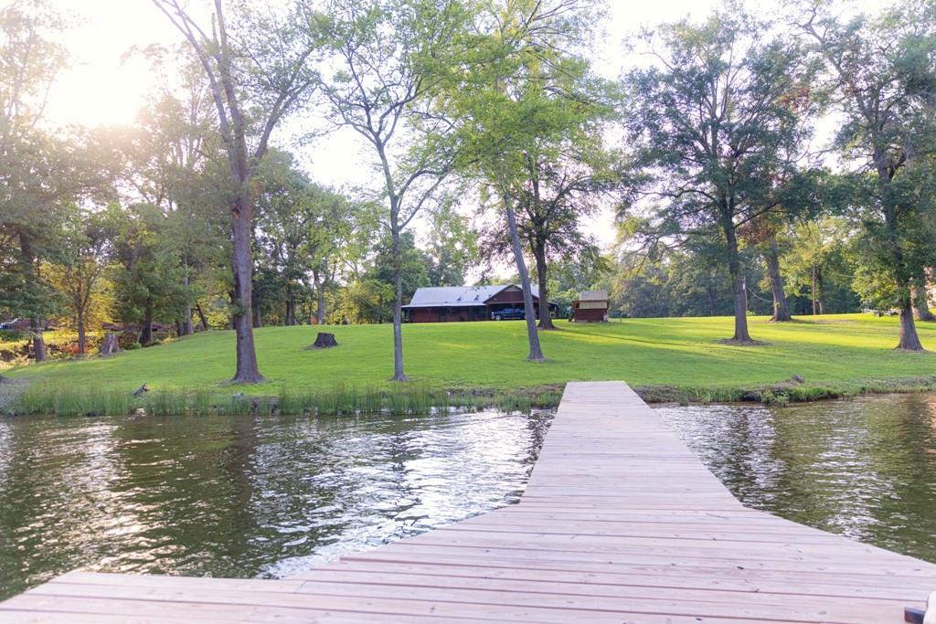 Peace, tranquility and all the amenities that beautiful Lake Bob Sandlin have to offer are waiting right here at your perfect Lakeside log home. Situated on 1.8 acres, the property offers plenty of room for expansion and entertainment .The home holds a nice cozy atmosphere and cabin like feel and the yard has plenty of shade for lakeside cookouts and gatherings. The property is located in one of the lakes original subdivisions with tenured residents and a full marina about a mile up the road. Enjoy long days on the water and relaxing evenings dockside watching the deer graze in the yard. Lake Bob Sandlin is located abut 2 hrs east of the Dallas Ft Worth area and is rapidly growing in popularity for weekend retreats like this on. Viewing by appointment only.