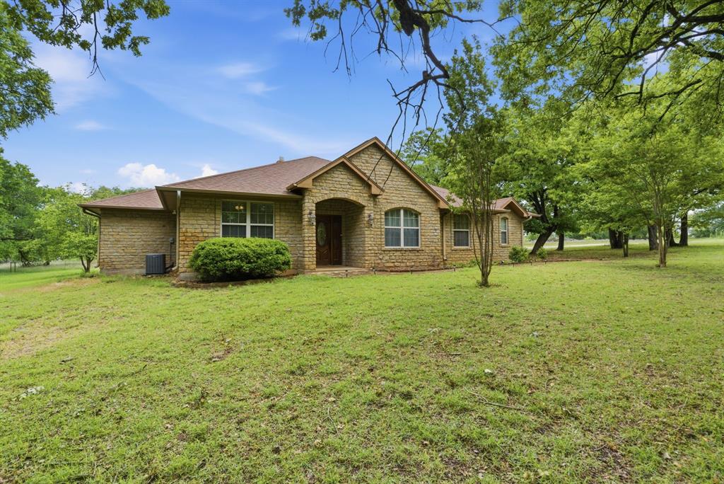 Privacy and serenity away from the bustle of town...off the beaten path...this is it!! 24 +- secluded acres with a Limestone construction single story ranch that is almost off the grid yet with all the amenities and still close to town! You can feed the deer off the back porch! Located in Stephenville, Texas in the heart of cowboy country this property has many features to share. Technically 3 bedrooms with a potential 4th bedroom or den-game room depending how you want to use it, whatever you want to call it, it is an enclosed oversized room waiting for you. Another great feature is a full office off the entry foyer with double French doors making it a very functional & spacious floor plan. Gorgeous stone fireplace with inset to add warmth & hearth to this ranchette. Nice country style kitchen with quaint breakfast nook area and large breakfast counter in front the sink for great conversation. Bedrooms 2 & 3 share a Jack & Jill bath with vanity sinks located outside the common shower room in each respective bedroom, so each bedroom has a sink-mirror inside it. The primary suite has plenty of closet and bathroom space with a French door offering direct access to the back patio. A super laundry service room of ample size with sink and built in cabinets greet you upon stepping inside from your 3 car garage. The flooring is one continuous large sized neutral colored tile throughout the home with a Texas mosaic at the foyer. The heavily wooded lush green oak trees provide awesome seclusion and plentiful hideout for the local deer herd and abundant wildlife that will come right up to the patio to say hello. Conveniently located within minutes to 377 Arena for great team roping or barrel racing, and 10-15 minutes to stores and shopping in town.