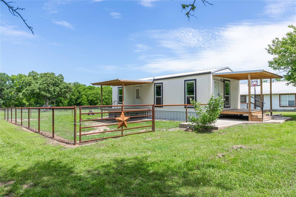 This 2025 Titan Tiny Home offers simple living with modern comfort, set on a 0.6074-acre lot within walking distance of downtown De Leon. Measuring 16x44, this 1-bedroom, 1-bath home offers a practical layout that makes the most of the space. It features a 100 sq ft front porch and a 220 sq ft back porch, giving you plenty of outdoor living and storage space. Inside, you’ll find an open living area with plenty of natural light, a functional kitchen that includes a refrigerator and oven, plus a stacked washer and dryer for added convenience. The bedroom offers a comfortable size space with a nice-sized closet. The property is partially fenced, including approximately 0.3 acres on the north side, along with a smaller fenced backyard that was previously used for inside animals. With over half an acre total, there’s room to spread out, garden, or add on if desired—while still being close to local shops and dining. Whether you're looking for a full-time home, a weekend getaway, or an investment, this property is a solid option.