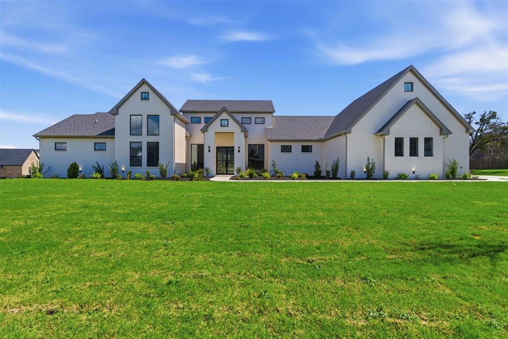 Welcome to 5825 Grey Wolf Ct, a striking custom home that blends modern luxury, thoughtful design, and resort-style outdoor living on an acre homesite. With 4 bedrooms, an additional flex room, and a spacious game room that can easily serve as a 5th bedroom, this home offers the flexibility today’s buyers are looking for.
Inside, the open-concept layout makes an immediate impression with soaring ceilings, expansive windows, abundant natural light, and a dramatic floor-to-ceiling fireplace anchoring the main living space. The kitchen was designed to stand out, featuring a large island, premium appliances, generous cabinetry, and a hidden pantry that adds both style and function. The dining and living areas flow seamlessly, creating an ideal setup for entertaining or everyday living.
The private primary suite offers a true retreat with vaulted ceilings, a spa-inspired bath, dual vanities, a freestanding soaking tub, oversized walk-in shower, and a large custom closet. Secondary bedrooms are well-sized, and the additional living spaces give you options for fitness, media, guests, or multigenerational living.
Step outside to your own backyard escape, complete with a covered patio, outdoor kitchen, and stunning pool that makes the most of the home’s wide open setting and scenic views. The long driveway, beautiful curb appeal, and custom exterior design add to the sense of privacy and presence.
A rare opportunity to own a thoughtfully designed custom home with high-end finishes, versatile living spaces, and unforgettable indoor-outdoor appeal on an entire acre of land. Zoned to top-rated Mansfield ISD.