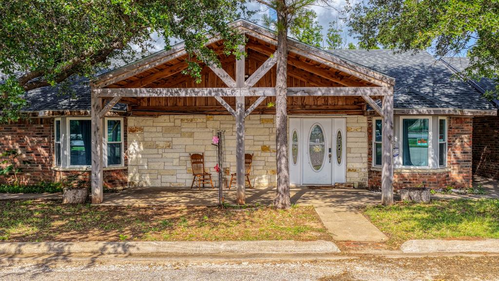 Rare opportunity in Hood County featuring 1.22 acres with potential industrial or commercial use possibilities. This unique property offers flexibility for investors, business owners, or buyer looking for live and work opportunity with room for equipment, storage, or future expansion.

The property includes an existing 3 bedroom 1 bath home ready for your vision and updates, making it an ideal fixer upper opportunity with endless potential. A large covered metal structure-shop area in the back provides ample space for machinery, vehicles, boats, workshop use, or additional storage.

Conveniently located near Lake Granbury with easy access to Granbury amenities, this property combines functionality, versatility, and investment potential.  Whether you're looking for a renovation project, or land with usable improvements already in place, this one offers a variety of possibilities.