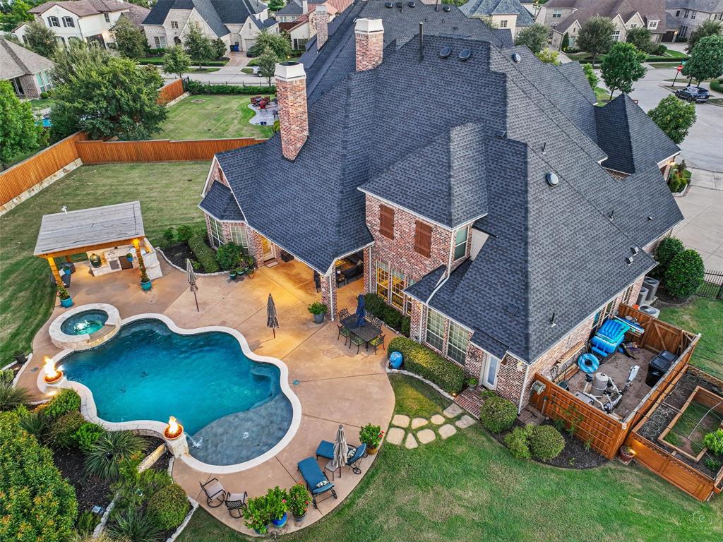 Welcome to this stunning French style home located in the prestigious guarded-gated neighborhood of Newman Village. This luxurious, most sought- after floor plan, 5 bedroom, guest suite down with MEDIA down home boasts over 5,000 square feet of living space, providing ample room for comfort and entertainment. As you enter the home, you are greeted by a grand foyer with cathedral ceilings and elegant decorative lighting throughout. The gourmet kitchen is a chef's dream, featuring a commercial grade range, butler's pantry, oversized island that seats up to 5 people with a breakfast room. The home also offers a wine room, exercise room, media room, study, laundry room with a sink, and a mudroom with built-ins for added convenience. The primary bedroom is located on the main floor and includes a sitting area and a lavish ensuite bathroom with an expansive double vanity, separate shower, jetted tub, water closet, and a spacious walk-in closet. Upstairs, you will find a game room and 3 bedrooms with ensuites and walk in closets. Media Room and Guest Suite is downstairs.  Plus, a full pool BATH. The outdoor space is just as impressive, with a covered patio featuring a fireplace, pergola with an outdoor kitchen, and a swing. The backyard oasis includes a swimming pool with a hot tub, water features, and fire features, perfect for relaxing and entertaining guests. Additionally, the property includes a garden, pool storage, and a fully fenced extra-large backyard. For car enthusiasts, the home offers two garages - a double garage and a separate one-car garage. This exquisite home truly has it all, combining luxury, comfort, and style in a highly desirable location. Don't miss the opportunity to call this French-inspired masterpiece your own.