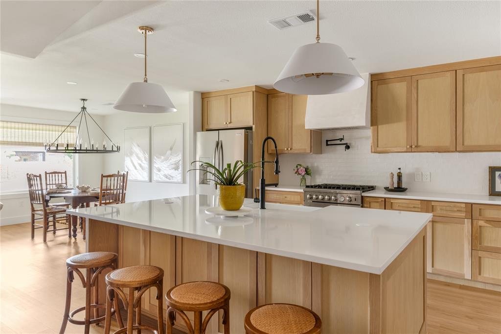 Beautifully reimagined with a warm modern aesthetic, this thoughtfully updated residence blends timeless character with elevated design and everyday functionality. Framed by mature trees and inviting curb appeal, the home welcomes you into light filled interiors where vaulted ceilings, wide plank wood flooring, designer lighting, and curated finishes create an atmosphere that feels both refined and effortlessly livable.Designed with both entertaining and daily life in mind, the open concept floor plan flows seamlessly from one space to the next. At the heart of the home is a stunning chef’s kitchen featuring custom oak cabinetry, quartz countertops, stainless steel appliances, and an oversized waterfall island that anchors the living and dining spaces beautifully. Expansive sightlines and architectural details throughout the main living area create a warm yet elevated feel, while large windows bring in abundant natural light and enhance the home’s seamless indoor outdoor connection.The spacious layout offers four bedrooms plus a dedicated office, providing flexibility for both work and relaxation. Each bedroom and bathroom continues the home’s elevated design story with soft tones, clean lines, and thoughtfully selected high end finishes that evoke a true retreat like atmosphere. Thoughtfully balancing modern updates with timeless style, this move in ready home delivers comfort, functionality, and sophisticated design in one beautifully executed package. This home also features significant updates, including new plumbing, electrical, roof, and an upgraded HVAC system!!