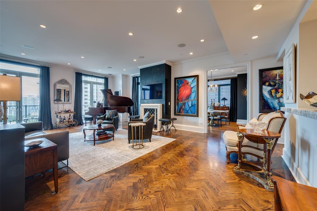Sophisticated Turtle Creek condo with unobstructed views of Dallas skyline and Turtle
Creek Park in a coveted 11th floor E unit containing additional square footage that
provides two bedrooms and three and a half bathrooms by design with south, west and
north facing windows, and four balconies.  Updated by current owners with all new LED
lighting and controls throughout, remote control blinds, Venetian plaster fireplace with new gas
logs and starter. Entertainment paradise with newly installed bespoke Neal Stewart
designed wet bar with glass cabinetry for display of glassware and beverage collection
with extensive storage and an undercounter refrigerator, plus a 500 bottle wine cellar
containing both linear and Bordeaux racks and a separate wine climate thermostatic
system. Kitchen redesigned with up and downlighting and a professional Thermador 48-
inch range which includes six gas burners, electric induction stovetop and oven plus
steam oven and warming drawer, and custom designed Portuguese tile backsplash.
New commercial vent hood includes warming lights. Primary bedroom suite with two
Carrera marble bathrooms and two walk-in closets with new closet systems. These
individual Vendome unit 11E condominium amenities include two underground, secured
deeded parking spots with dedicated EV charger connection and direct elevator access
to the 11 th floor, and are complemented by The Vendome’s heated pool and hot tub with
cabana alcoves, gas grills and covered outdoor dining, fitness center, lockers with dry
sauna, business center, secure dog run, catering kitchen and event space plus library,
manicured grounds and three on-site hotel suites for guests. All utilities except
cable-internet are included in HOA dues which provide full-time Vendome cleaning,
porters, and engineering staff, and a 24-hour concierge with two valets for door-to-door
service of any needs providing true lock and leave flexibility.