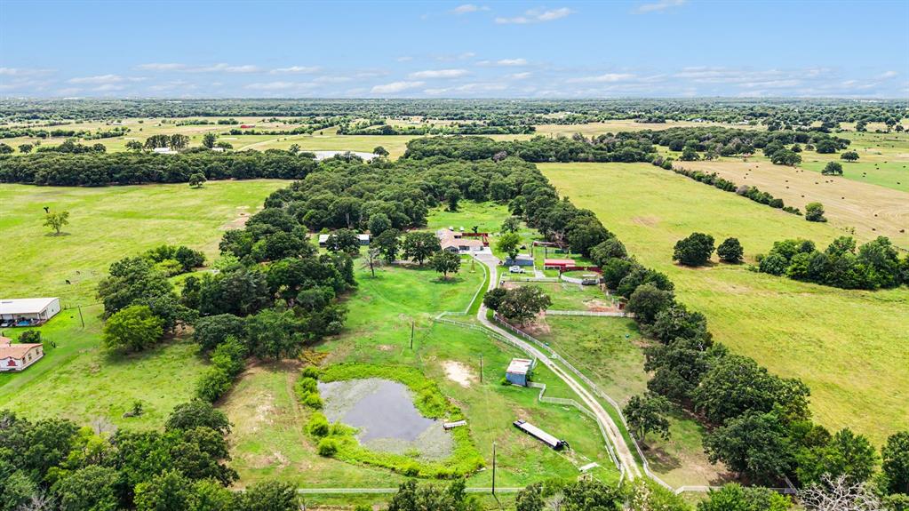 Equestrian enthusiasts will appreciate this exceptional 19.8± acre horse property, offering the perfect blend of country living, functionality, and modern comfort. The spacious residence features 6 bedrooms, 4.5 bathrooms, and a 2-car garage, with extensive updates completed in 2020. Designed for flexibility, the home includes a private living suite with its own entrance and kitchenette—ideal for guests, extended family, or multi-generational living.
The bright, open-concept interior creates a welcoming atmosphere, while the outdoor amenities are tailored for serious horse owners and livestock operations alike. The property includes round pens, a dedicated stud area with two 20x20 stalls, wash racks, a loafing shed and working cattle chutes. Fully fenced and cross-functional, the acreage also features a large workshop with ample space for equipment, hobbies, entertaining or additional storage.
Relax on the screened front porch and take in sweeping views of the surrounding countryside. Combining peaceful rural living with impressive equestrian facilities, this property is ready to accommodate both your lifestyle and your animals.