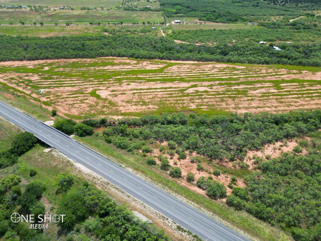 This property boasts 149.8 acres of land which offers a mix of natural beauty, recreational opportunities and the potential for a peaceful lifestyle. Located about 1.5 miles from Taylor County and close to a mile of highway frontage road, makes this land versatile and easily accessible.  The entrance off the highway was cleared and at one time offered a shooting range with stands, targets and berm. Mill Creek runs through a good portion of the land which offers a seasonal water source, both aesthetically pleasing and provides potential recreational activities including hunting or raising livestock. Nestled next to the creek is a 2010 mobile home with a large wooden deck along with a few improvements, including a 3 car metal carport.  There is a current AG exemption in place.  Property is being sold as is.  All non-realty items convey. The property is fenced and cross fenced for a number of uses and contains a few tanks.  Please book your showing today.