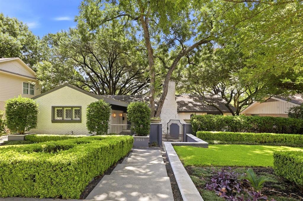 Nestled within one of Lake Highlands' most sought-after neighborhoods and zoned to prestigious White Rock Elementary, this exceptional single-story residence offers timeless architecture surrounded by a breathtaking park-like setting. Mature trees, extensive lush landscaping, and a spectacular front courtyard create a private oasis, welcoming guests with incredible curb appeal and an inviting outdoor entertaining space. The grand living room is the heart of the home, showcasing soaring vaulted beamed ceilings, handsome plank wood ceilings, dual ceiling fans, a striking white painted brick fireplace, and custom built-in's. Expansive windows fill the home with natural light while seamlessly connecting the indoor and outdoor living spaces. The elegant dining room is highlighted by a statement chandelier and French doors that open directly to the courtyard. Just beyond, the charming breakfast nook features built-in bench seating. The gourmet kitchen is equipped with granite countertops, a built-in refrigerator, gas cooktop, double ovens, abundant cabinetry, and generous prep space to inspire any home chef. The oversized primary retreat provides a peaceful escape, complete with a spacious sitting area and a beautifully appointed en-suite bath designed for relaxation. A light-filled sunroom serves as the perfect second living area, game room, or reading lounge while offering picturesque views of the expansive backyard. Three additional guest bedrooms are generously sized and complemented by two beautifully updated bathrooms finished with luxurious marble details. The private backyard continues the home's tranquil atmosphere with an expansive open deck surrounded by mature landscaping, creating the perfect setting for outdoor dining, entertaining, or simply enjoying the peaceful surroundings. Don't miss the temp controlled wine cellar in the garage. Don't miss your chance to call this house, HOME