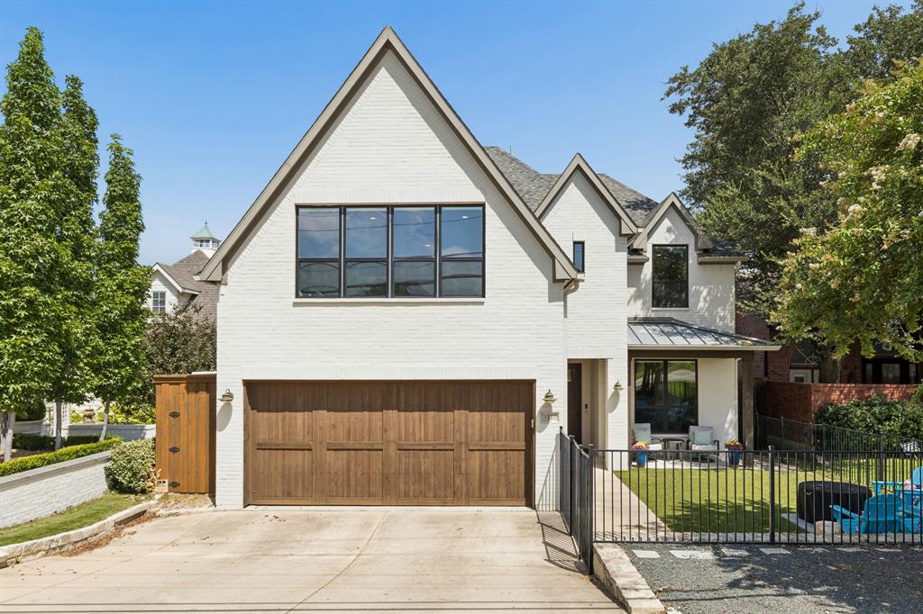 Perched with coveted views of Flag Pole Hill, this exceptional 2018-built home blends timeless architecture with sophisticated modern living.
Step inside to rich hardwood floors and a dramatic wood-and-iron staircase framed by soaring ceilings. A dedicated office offers a quiet retreat for working from home, while the open-concept dining area flows effortlessly into a chef's kitchen featuring an oversized island, sleek white cabinetry, premium stainless appliances, and a wine fridge — perfect for entertaining.
Four spacious bedrooms include a serene primary suite with a spa-inspired bath boasting a freestanding soaking tub, glass-enclosed shower, and dual vanities. Upstairs, a game room with vaulted ceilings and picture windows overlooking Flag Pole Hill offers flexible space for movie nights or a second lounge. Outside, a turfed backyard makes for easy, low-maintenance entertaining.
Ideally located in Lake Highlands and zoned to White Rock Elementary, this home offers easy access to White Rock Lake's trails, parks, and recreation — a rare combination of elevated design, function, and location.