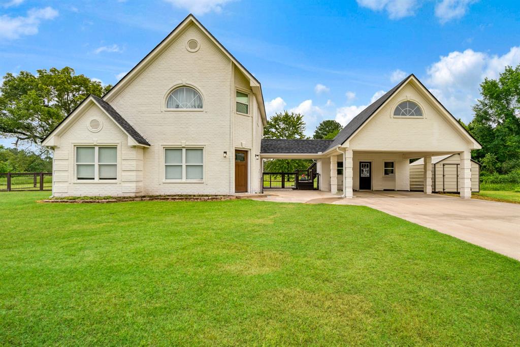 Welcome to this beautifully maintained country property offering the perfect blend of modern comfort and peaceful rural living. Situated on a spacious, fenced lot, this charming home features an inviting open-concept layout with soaring vaulted ceilings, abundant natural light, and a warm, airy feel throughout. The kitchen is thoughtfully designed with crisp white cabinetry, generous counter space, modern appliances, and a functional layout ideal for both everyday living and entertaining. The spacious living area flows seamlessly into the dining and kitchen spaces, creating a comfortable atmosphere perfect for gatherings.

The primary suite serves as a private retreat with a spa-inspired bathroom featuring a freestanding soaking tub, oversized walk-in shower, dual vanities, and stylish finishes. An additional bedroom downstairs provides comfortable accommodations for family or guests, while the third bedroom or flexible office space is privately located above the carport, offering the perfect setup for remote work, hobbies, or additional guest space.

Outside, the expansive yard offers plenty of room to enjoy outdoor living, recreation, gardening, or simply taking in the peaceful country setting. The property also includes covered parking and additional outdoor space with endless possibilities. With modern updates, timeless design elements, and room to spread out both inside and out, this property delivers the ideal balance of comfort, functionality, and country charm.