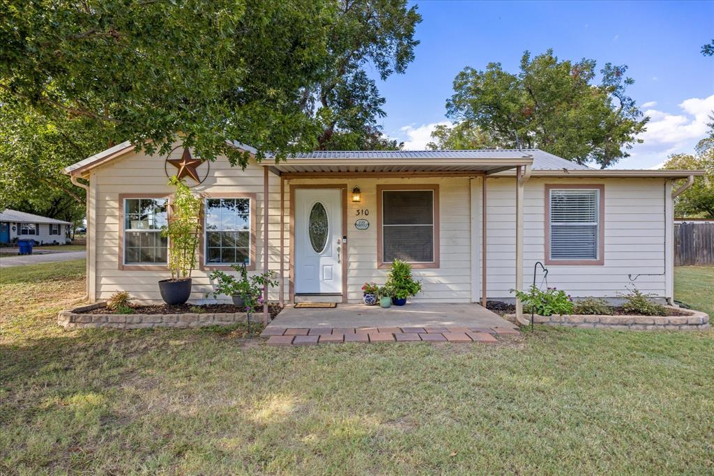 PRICE CHANGE:  Charming Farmhouse in Tolar ISD!!!  Set on a spacious corner lot with large mature pecan trees, this home is in the desirable community of Tolar, known for its highly rated schools (Tolar ISD).  Amazing close-in location, just a short walk to main street shops and restaurants.  You’ll love the open, light, and bright layout with brand new luxury vinyl plank flooring throughout, new paint & baseboards. The floor plan includes 2 bedrooms, 2 full baths, and a large kitchen with ample counter space, plus an adjacent dining area perfect for family meals.  The home features metal roofs (for durability and low maintenance) on all 3 buildings.  Enjoy extra space & storage (house, garden-laundry shed (14'X10') and workshop-storage building-with insulation, electrical & generous shelving-storage (18'X23'). Recent updates include wide plank laminate flooring throughout, new baseboards and fresh paint. New rain gutters, new block & base foundation and a Trane HVAC system installed in 2020. Outdoors, the fenced backyard with a large patio creates an inviting space for entertaining or relaxing under the mature pecan trees. It's a great back yard ready for your cookouts and s'mores. A workshop with electrical, lighting, and shelving provides space for projects or storage, while an additional shed offers a laundry room with space for gardening or workouts. The oversized lot allows parking for an RV, boat, or extra vehicles, all enclosed by a wood privacy fence and additional large grass area that can be enclosed. This home blends small-town charm, modern updates, and a prime corner lot with walkability—a wonderful find in Tolar!  A short drive away you will find Granbury-Voted the Best Small Historic Town in the USA for the 3rd year running and recent the Celebration Capital of Texas.  In addition to small town living you have access to the DFW metroplex and DFW International Airport.  Country & City living at it's best.  COME SEE TODAY!