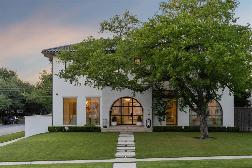 Stunning transitional home built by Danes Custom Homes on a 10,993 SF corner lot. Custom steel doors and windows with a stucco-limestone facade and concrete tile roof. A grand foyer with exquisite metal staircase, an airy open floor plan with white oak floors throughout provides effortless entertaining. The kitchen is a culinary dream, showcasing calacatta marble counters, dual sinks for prepping, built-in coffee maker, double ovens, double refrigerator with freezer drawers, expansive glass wine fridge and an adjacent butlers pantry.  Luxurious finishes throughout, sleek dining and living areas. The veranda boasts large sliding doors for a seamless indoor-outdoor flow, a cozy fireplace with central heat & AC, that looks out onto the tranquil pool with manicured landscaping and turf yard. The master suite opens up to an elegant pool with a cascading fountain wall.  The master bath is spa-like, grand marble shower, floating tub, his and her vanities, and separate walk-in closets.