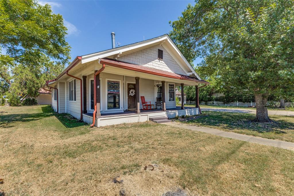 Full of character and charm, this one of a kind 1928 beautifully renovated home sits behind a white picket fence on a large corner lot with mature trees.  This 3 bed, 2 full bath home has updated kitchen and baths, custom wood floors, butcher block countertops and a large front porch.  Perfect for entertaining, the almost half acre lot has a backyard gazebo, fire pit, and sitting area under the garage porch with plenty of room for 2 cars plus a room for storage space.  HVAC system replaced May 2024.  Roof was replaced in March 2025.  Prime location close to downtown Crandall with driveways on both Church and 4th Street.