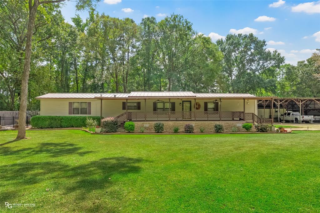 Back on the Market. Engineers Report Completed. Move-In Ready and FHA, VA, and Conventional Eligible.

This one-owner, meticulously maintained 1988 manufactured home sits on 0.66 acres in peaceful Haughton, Louisiana. Offering 3 bedrooms, 2 bathrooms, and 1,440 heated square feet, it combines comfort, practicality, and rural serenity with every major feature already in place.

The property includes a new metal roof installed in 2020, a strategically engineered five-car covered carport, and a large storage and workshop area ideal for boats, ATVs, and trailers. Inside, the home remains in excellent condition, clean, move-in ready, and thoughtfully maintained. Buyers may choose to personalize with minor cosmetic updates, but the home is turnkey as it stands.

Outdoor spaces are a highlight. The front covered porch, patio, fenced yard, and landscaping are all immaculate. Additional features include a sprinkler system, security cameras, and appliances that remain with the home including the washer, dryer, refrigerator, entertainment center, and drapery.

Utilities include a septic system with city water, natural gas, and SWEPCO electric service. The location offers the perfect blend of privacy and convenience, just minutes from I-20 with easy access to Bossier City, Shreveport, shopping, dining, and medical facilities, yet set in a quiet and safe neighborhood perfect for outdoor play and relaxation.

Schools: T.L. Rodes-Platt-Princeton, Haughton Middle, and Haughton High.
Financing: FHA, VA, or Conventional loan types.
