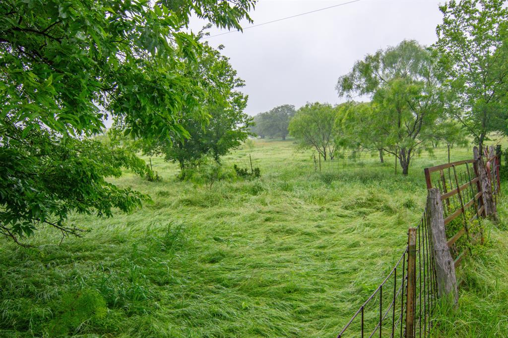This versatile 112-acre property offers a rare combination of commercial potential and recreational charm. This property is located near an electrical substation, and  presents strong possibilities for future development, including a data center site, switching station, or solar farm.

With approximately 2,650 feet of frontage along the north side of CR 210 and an additional 2,800 feet along the east side, access is excellent via a county-maintained, all-weather road. The location is convenient—just 1.2 miles south of Hwy 36 and 2 miles southeast of Comanche—while still offering privacy and wide-open space.

The land itself is mostly open with gently rolling terrain and roughly 50 feet of elevation change, complemented by scattered mature oak trees and native hardwoods. For those seeking recreational or agricultural use, the property is well-equipped with average fencing suitable for livestock, three small stock tanks, a good set of working pens, an old barn and windmill, and a recent water well. There is also electric at the property. 

Whether you’re looking to invest in future commercial development or enjoy a functional and scenic ranch property, this tract offers outstanding flexibility and long-term potential.