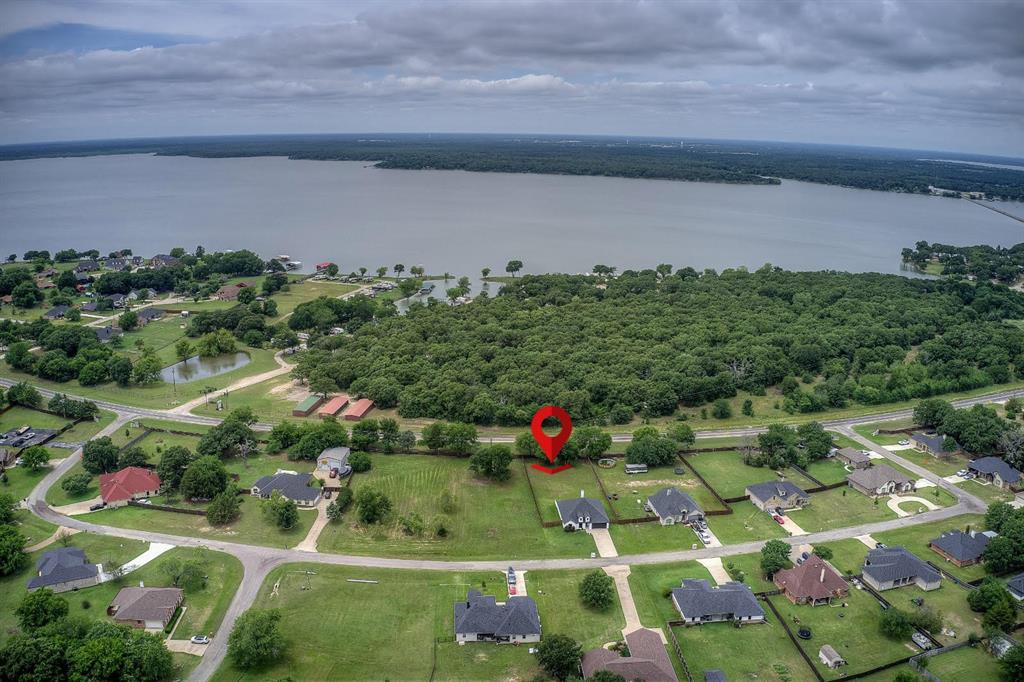 Nestled within the Waters Edge community, this home offers a refined blend of tranquility and lakeside living. Situated on nearly half an acre with a fully fenced backyard featuring steel posts and cedar fencing in 2023, this property delivers the perfect balance of elevated comfort and everyday functionality within a serene setting. No neighbors behind you, privacy and peaceful surroundings abound.
Residents enjoy exclusive access to a PRIVATE gated year-round marina with dock and fishing access, creating an lifestyle centered around relaxation and recreation. Boat slips are also available for only residents for under $300 per year! You read that right! Enjoy lakeside lunches beneath the pergola or gathering with friends and family at the picnic tables overlooking the water. HOA is only $300 year!
Designed for both entertaining and comfortable daily living, the open-concept floor plan creates a bright and elegant atmosphere throughout the home. The kitchen features newly painted cabinetry with updated hardware, tall custom wood cabinets, quartz countertops, and seamless flow into the spacious main living area. An upgraded tiled fireplace serves as a stunning focal point, adding warmth and sophistication to the space.
The spacious primary suite offers a private retreat with an elegant ensuite bath featuring upgraded tile flooring, tiled shower, a garden tub with double sprayers, and generous multi-level closet. 
Designed with efficiency in mind, the home also includes solar screens to help reduce energy costs.
Complete with a two-car garage with built-in shelving & fresh paint on garage door. Large side gates to pull in the backyard. Less than a mile from the fire station, approx 15 minutes from Terrell, just 5 min from Hwy 276, and less than 2 min from additional public boat ramp & fishing area. Nearby shopping and restaurants, this home offers more than just a place to live it offers a lifestyle of comfort and escape.